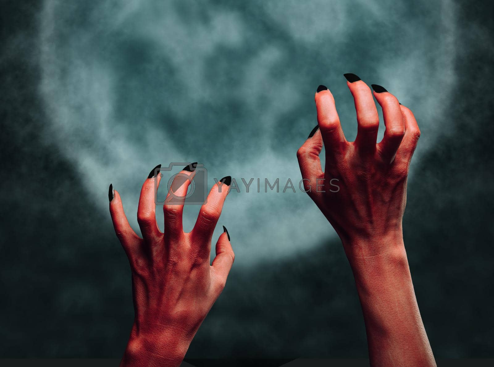 Royalty free image of Hands of the demon at midnight by alexAleksei