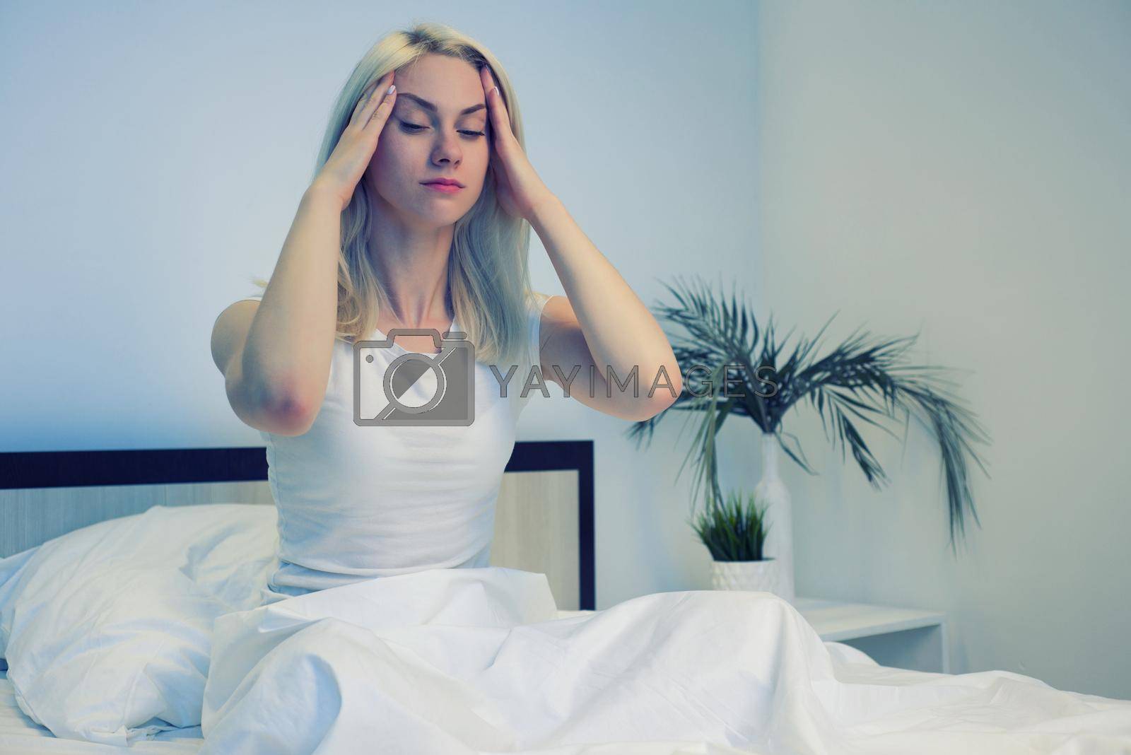 Royalty free image of Depressed woman awake in the night, she is exhausted and suffering from insomnia by zartarn