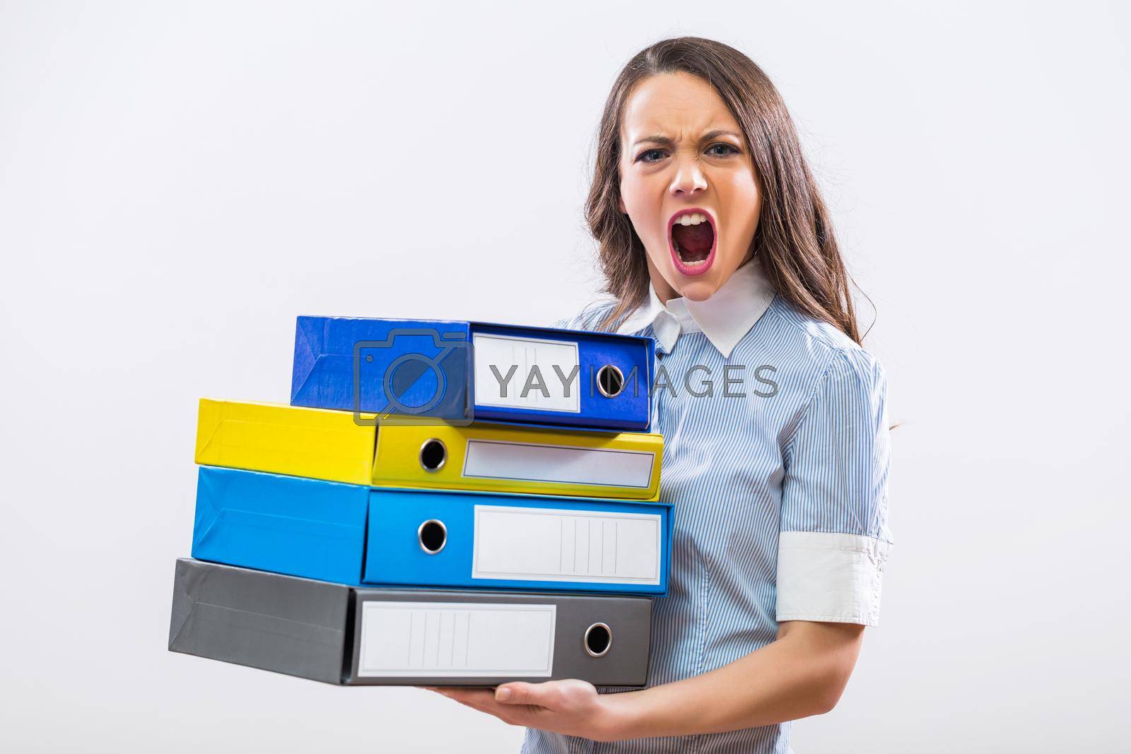 Royalty free image of Furious businesswoman holding office archives by Bazdar