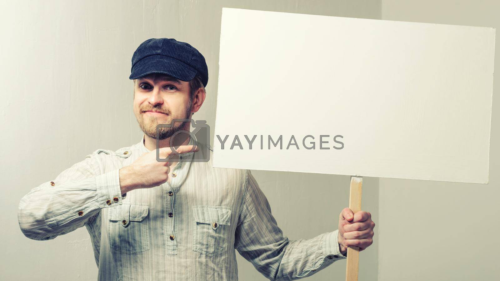 Royalty free image of Angry protesting worker with blank protest sign by zartarn