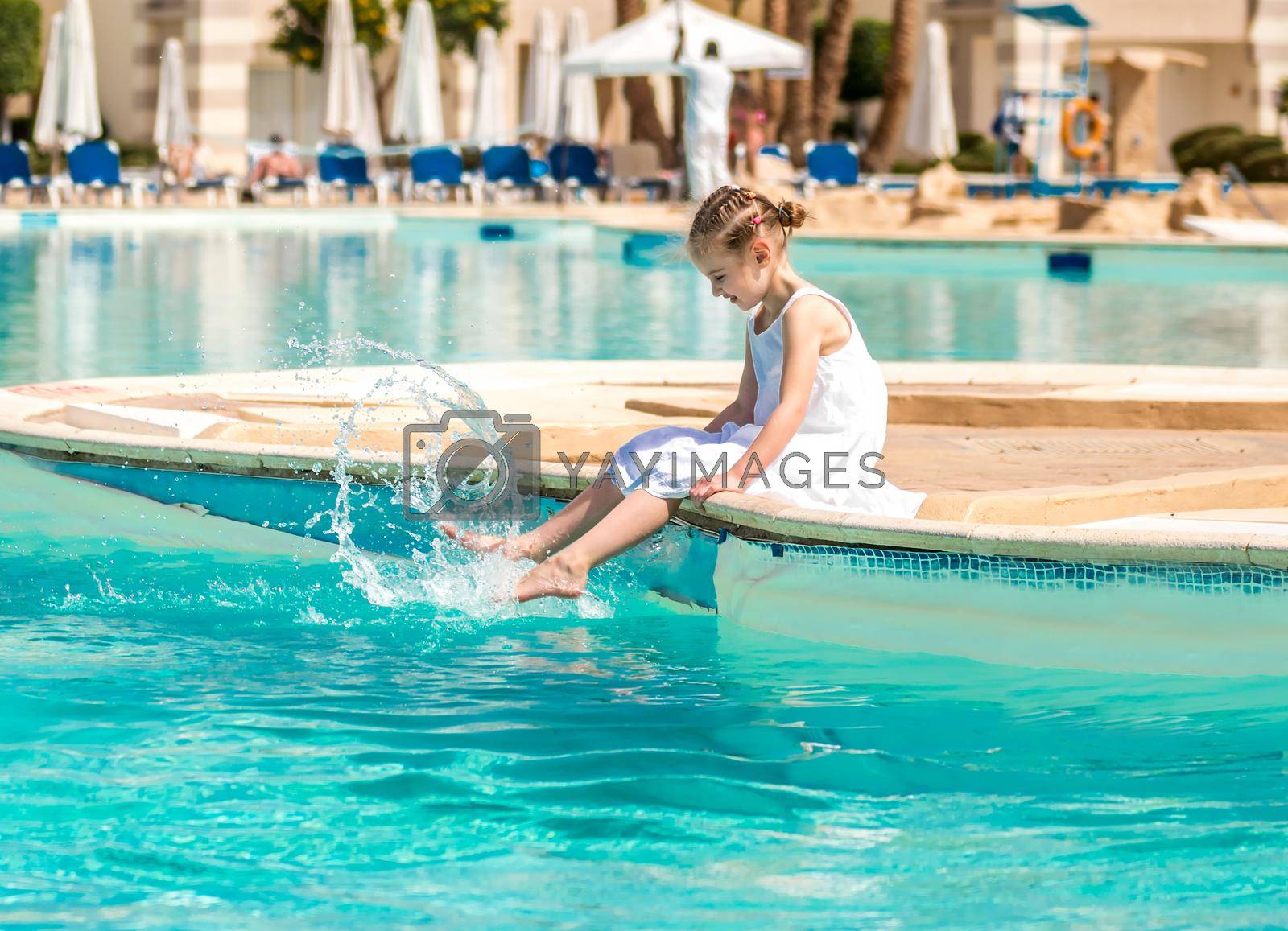 Royalty free image of Kid doing activities by the pool by tan4ikk1