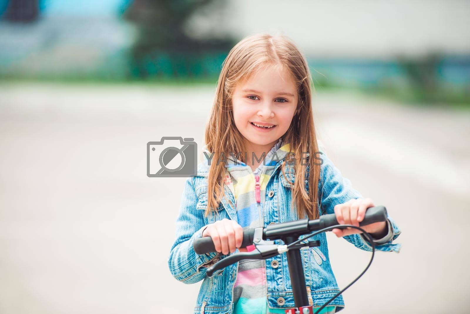 Royalty free image of Little girl with scooter by tan4ikk1