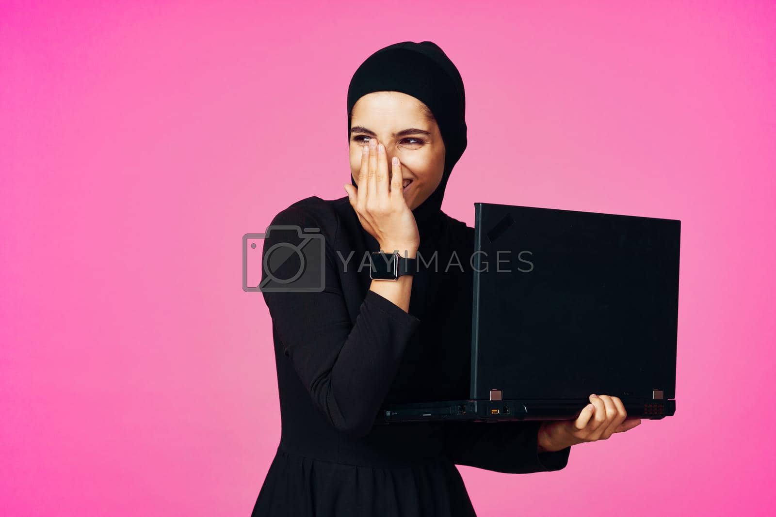 cheerful muslim woman with laptop education student internet technology. High quality photo