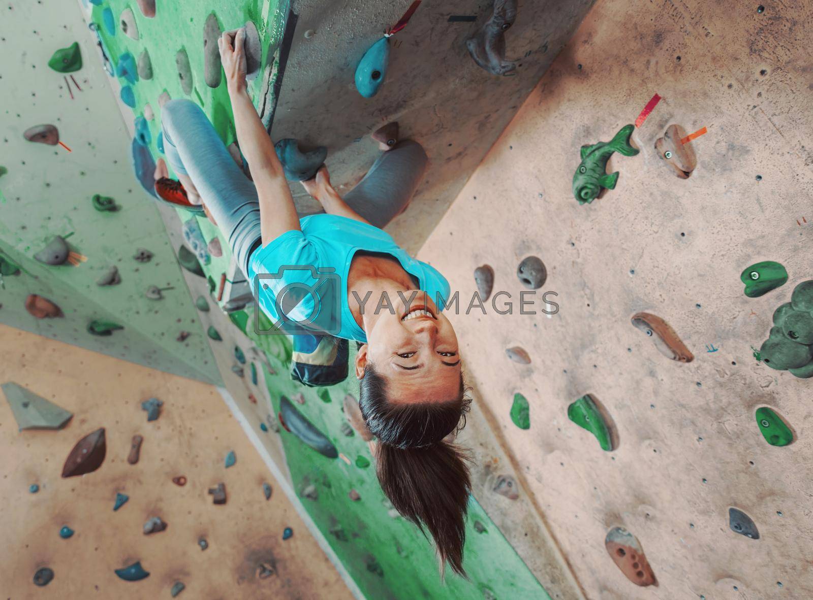 Royalty free image of Happy sportswoman climbing indoor by alexAleksei