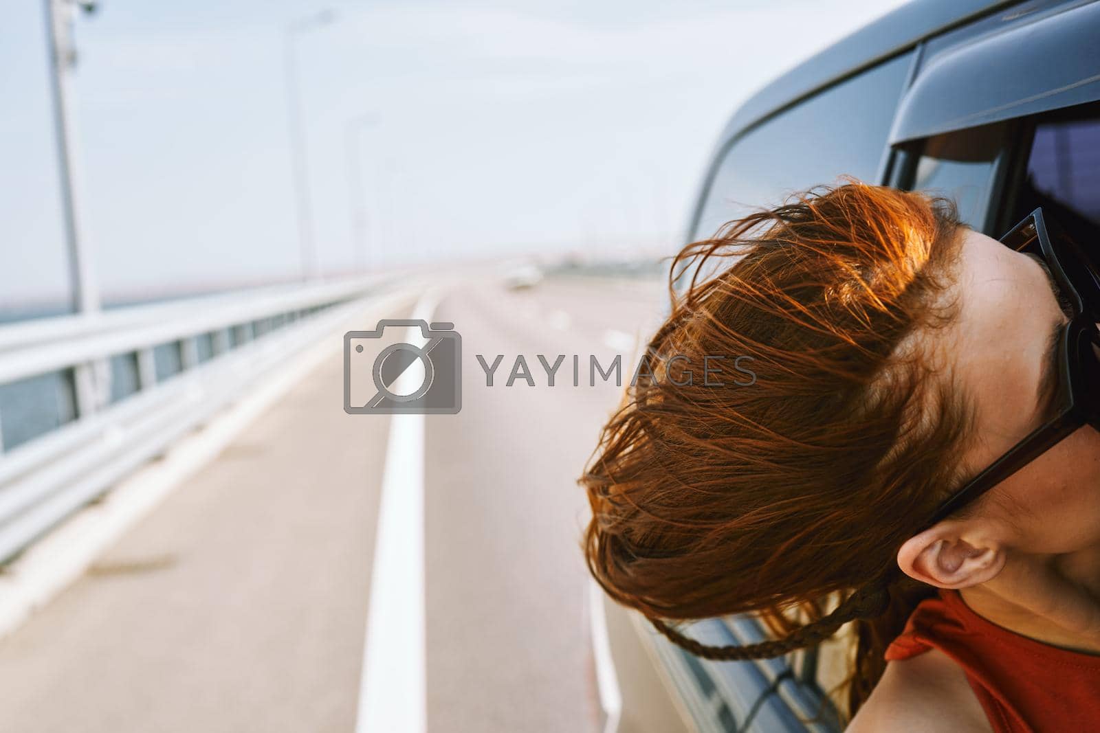 woman looking out of car window wearing sunglasses travel lifestyle. High quality photo