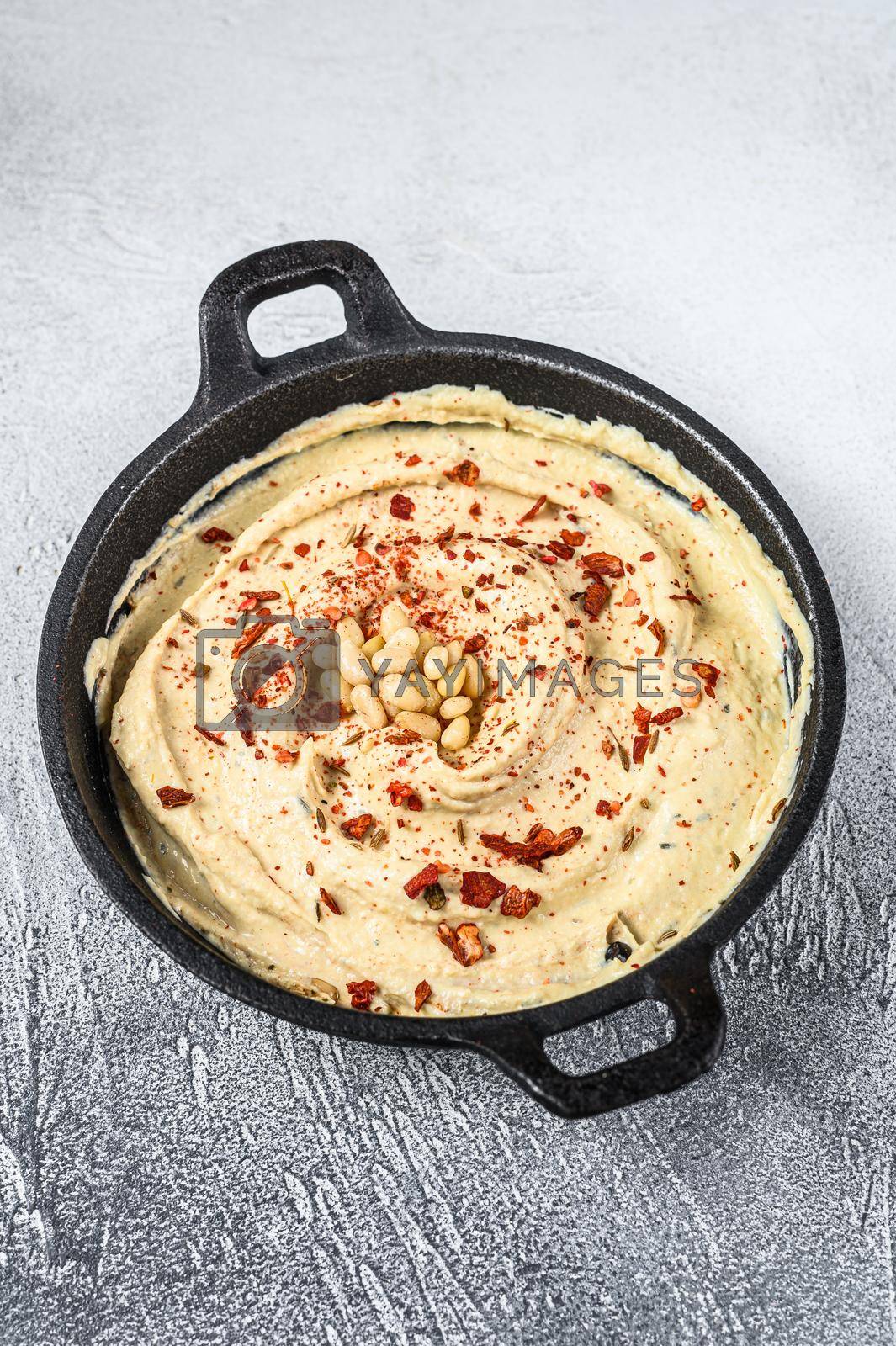 Royalty free image of Hummus dip with chickpea in a bowl. White background. Top view by Composter