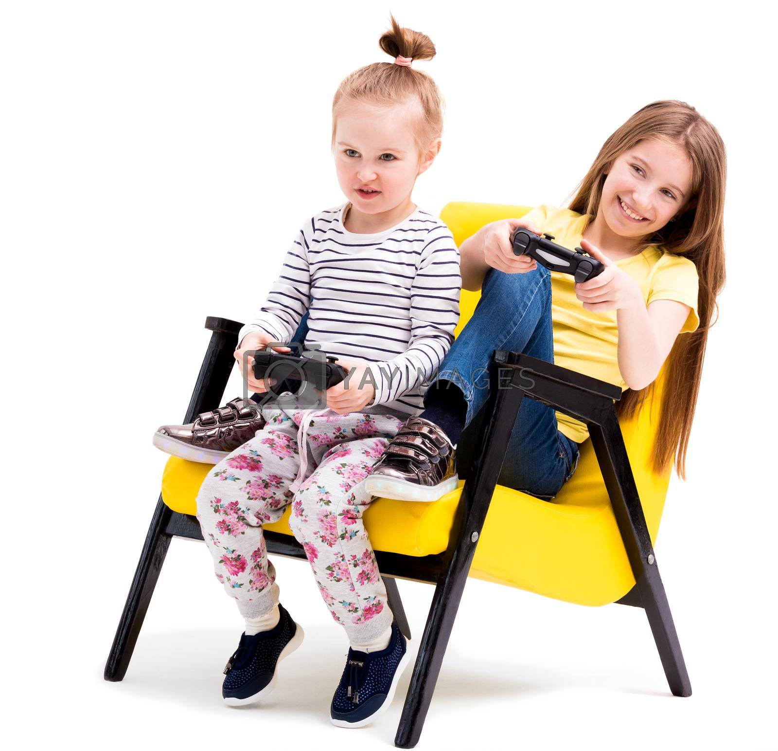 Royalty free image of Siblings playing battles with joystick by GekaSkr