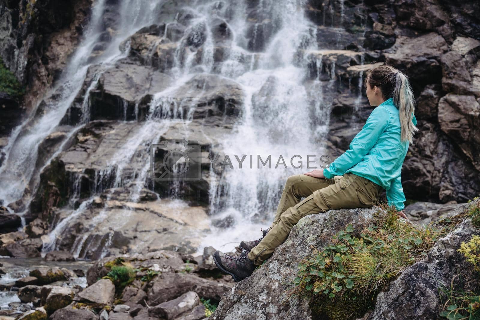 Royalty free image of Woman enjoying view of waterfall by alexAleksei
