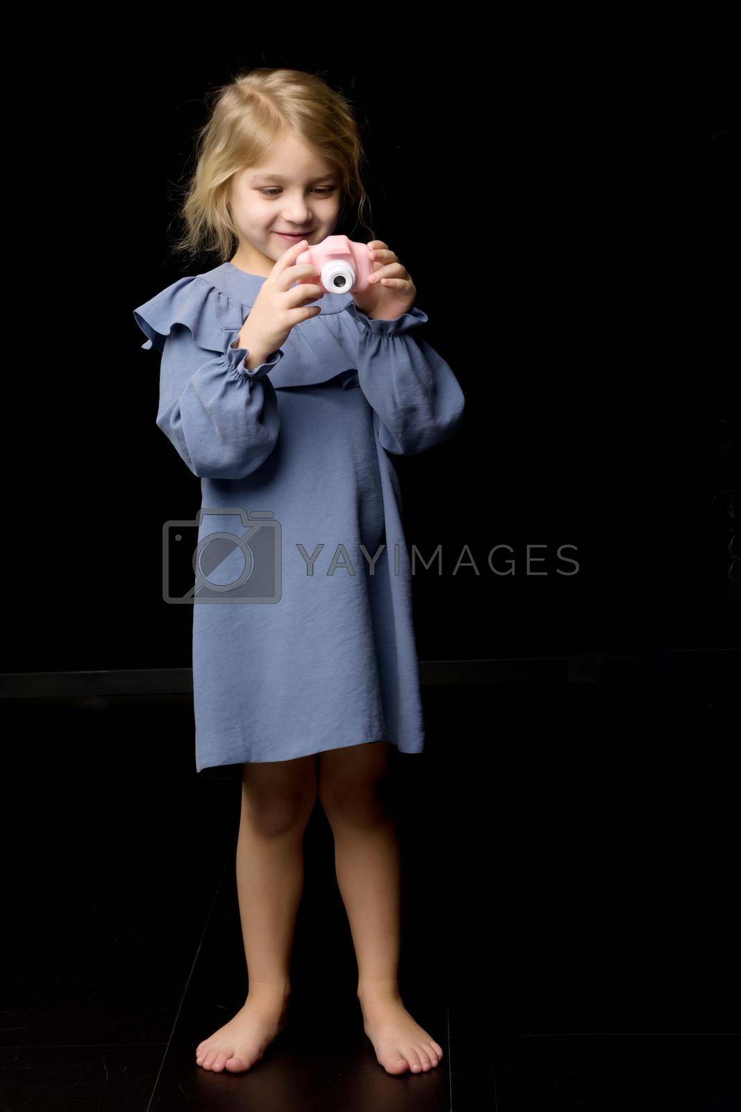 Royalty free image of Beautiful Barefoot Girl Taking Photo with Toy Camera by kolesnikov_studio
