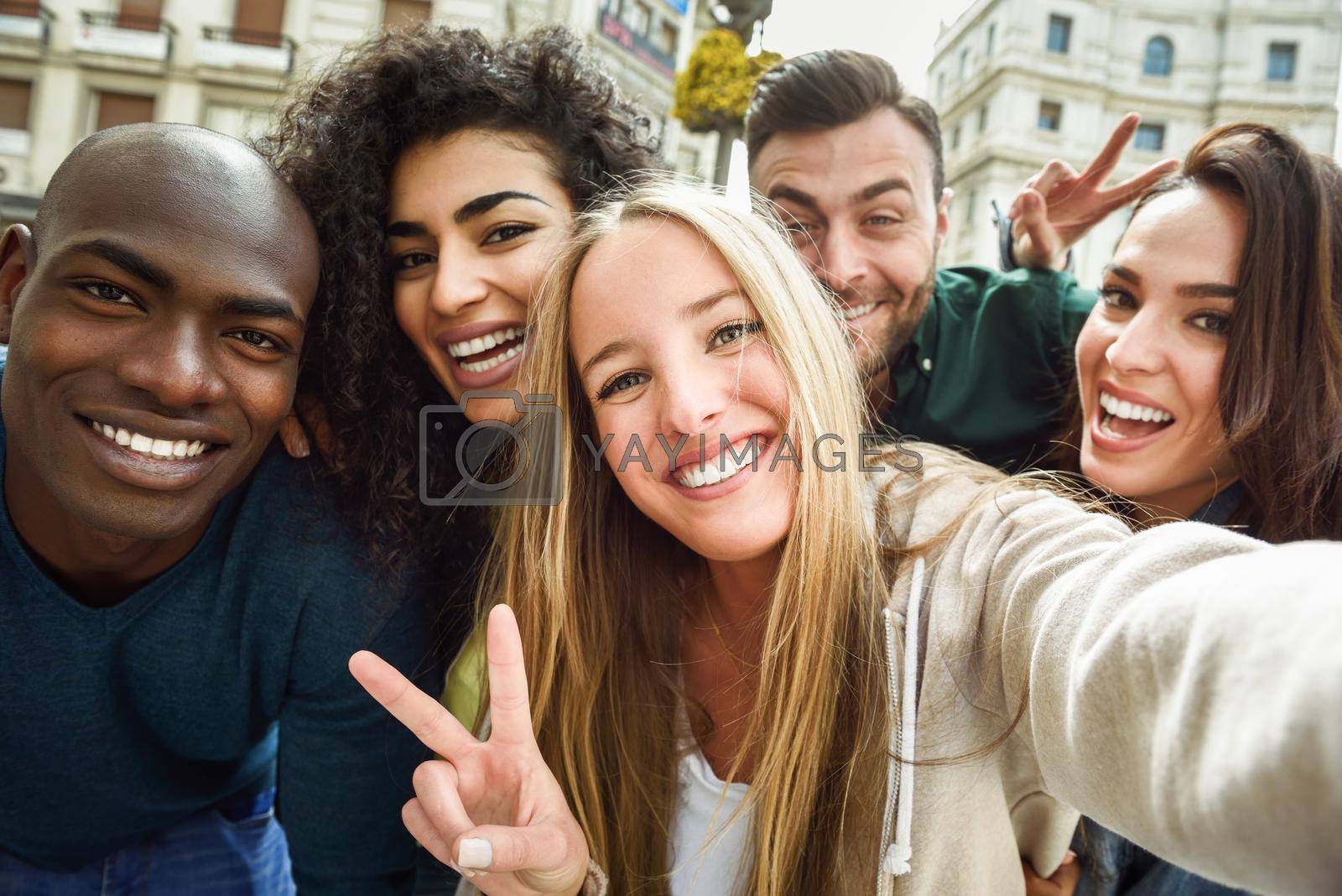 Royalty free image of Multiracial group of young people taking selfie by javiindy