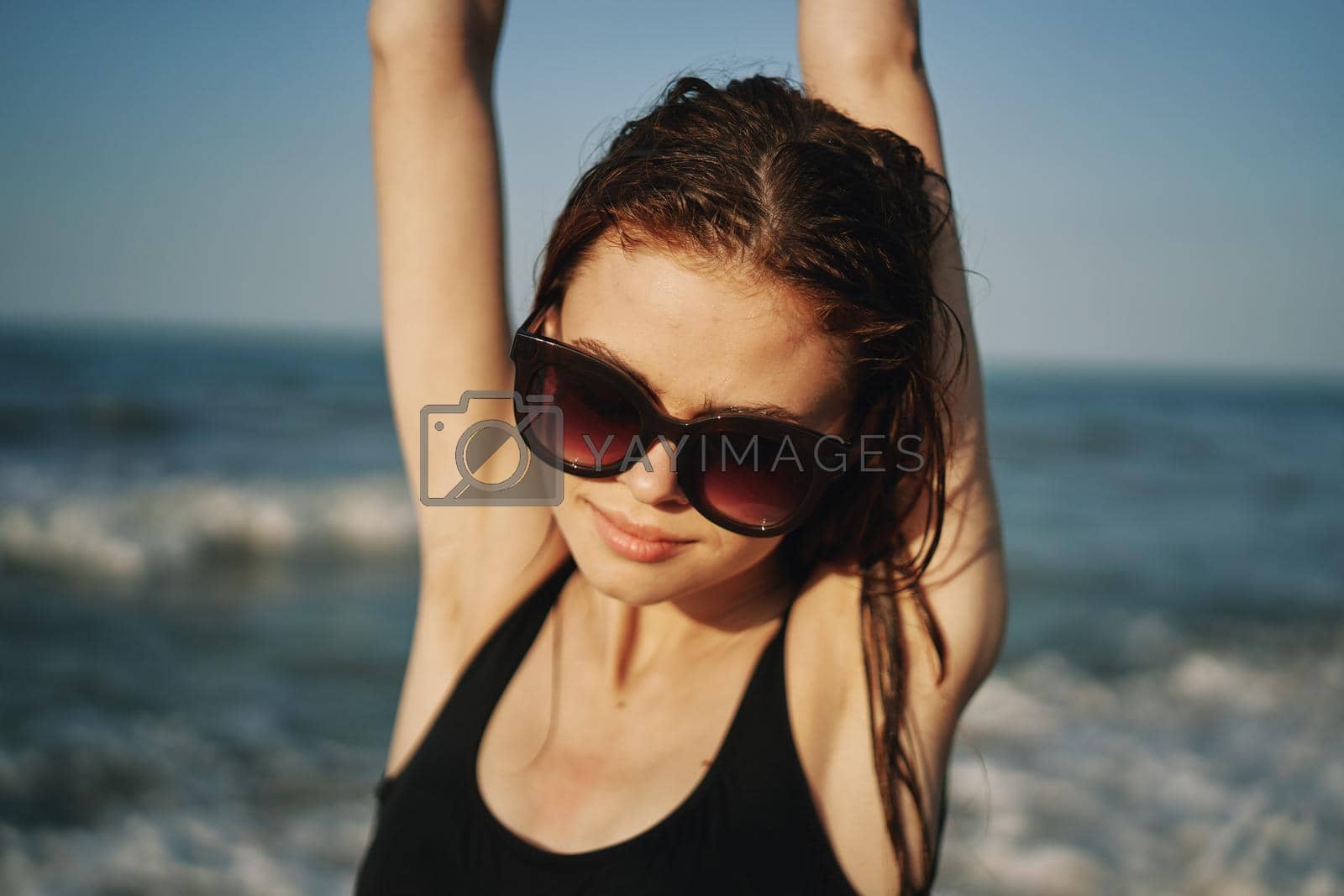 cheerful woman in black swimsuit sunglasses ocean travel. High quality photo