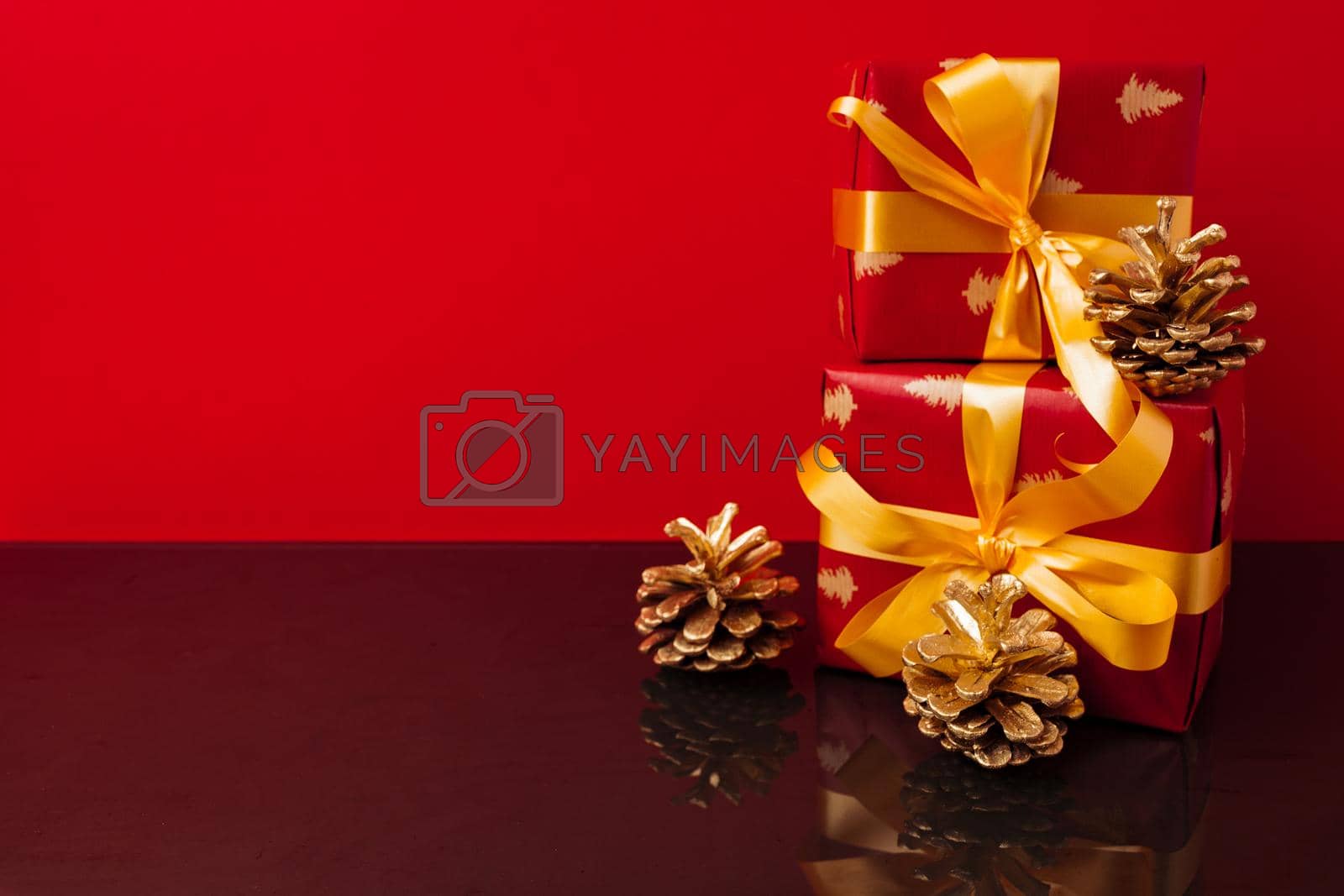 Royalty free image of Several stacked Christmas gifts in festive wrapping by Fabrikasimf
