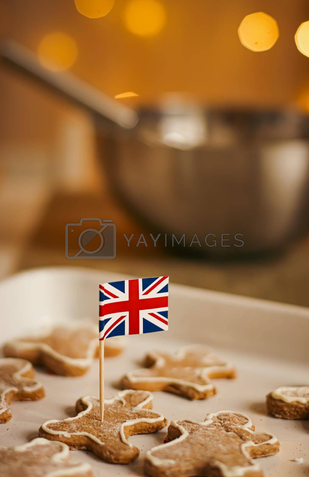 Royalty free image of British holiday and Christmas baking concept. Union Jack flag of Great Britain and gingerbread men biscuits in the kitchen in England by Anneleven
