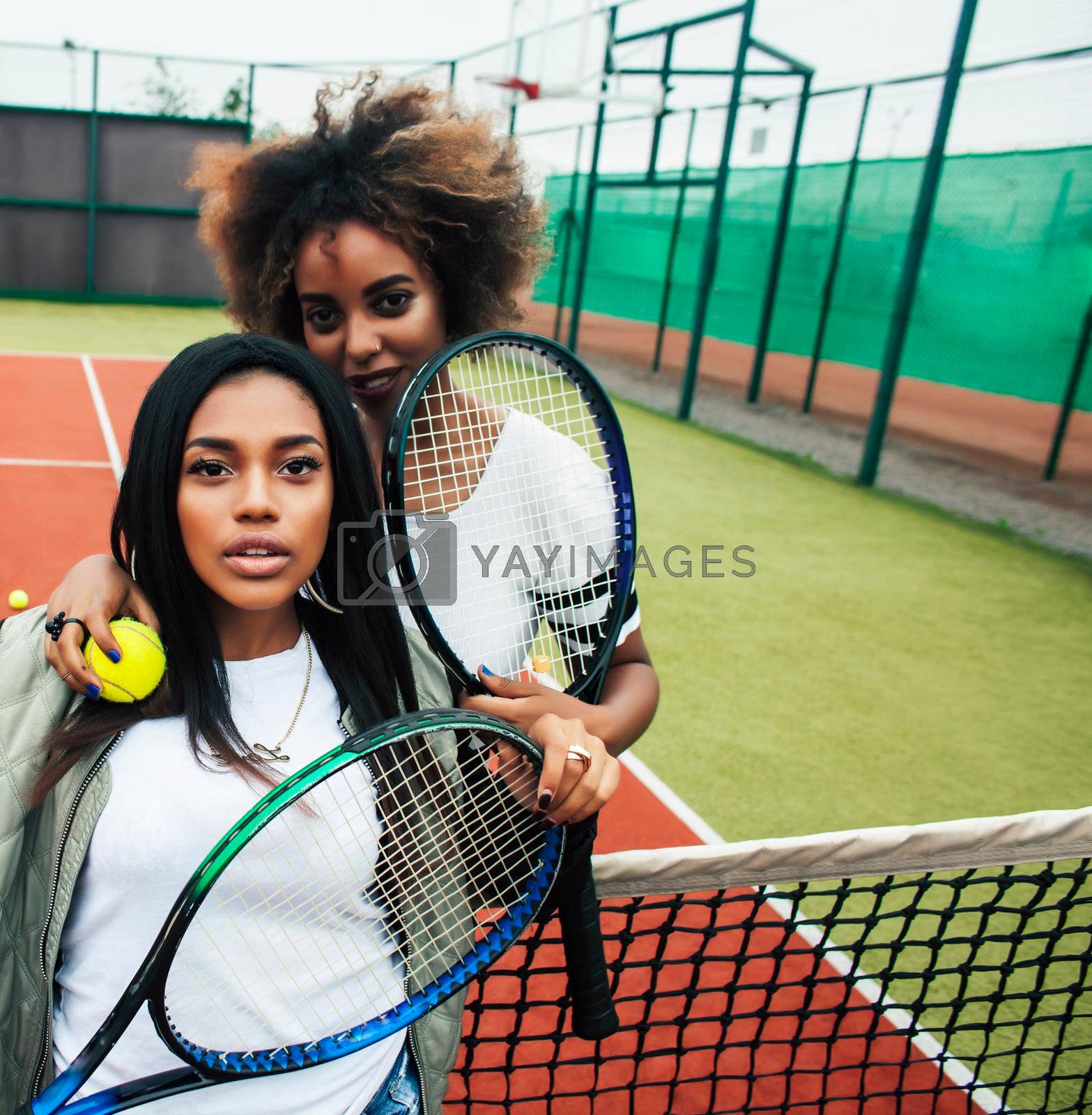 young pretty girlfriends hanging on tennis court, fashion stylish dressed swag, best friends happy smiling together lifestyle close up