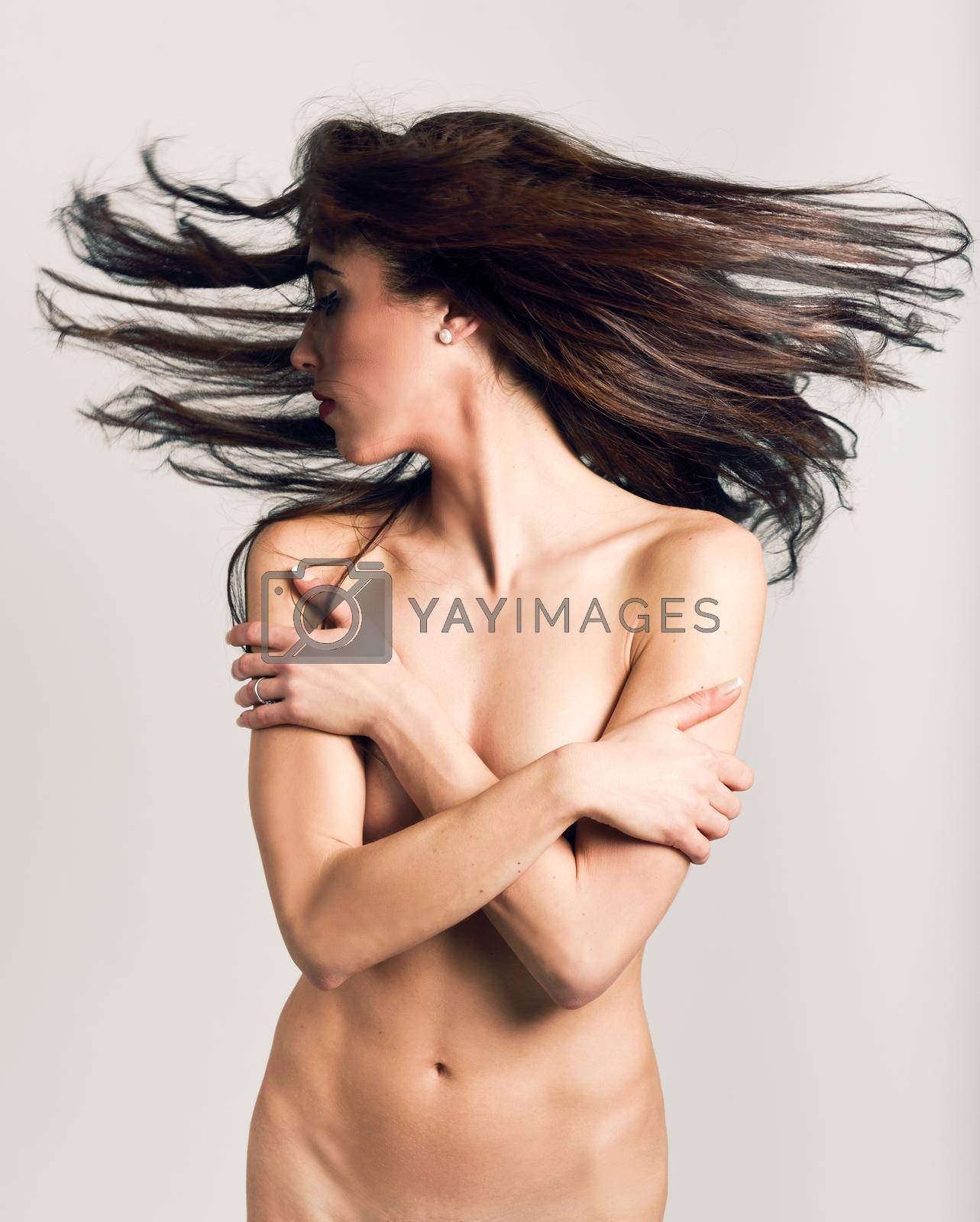 Royalty free image of Nude woman with moving hair on white background by javiindy