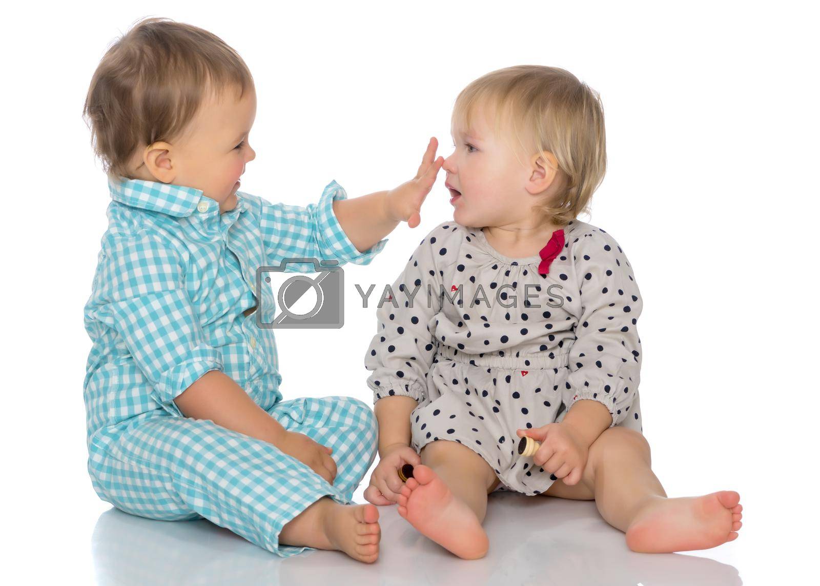 Royalty free image of Babies boys and a girl cute embrace. by kolesnikov_studio