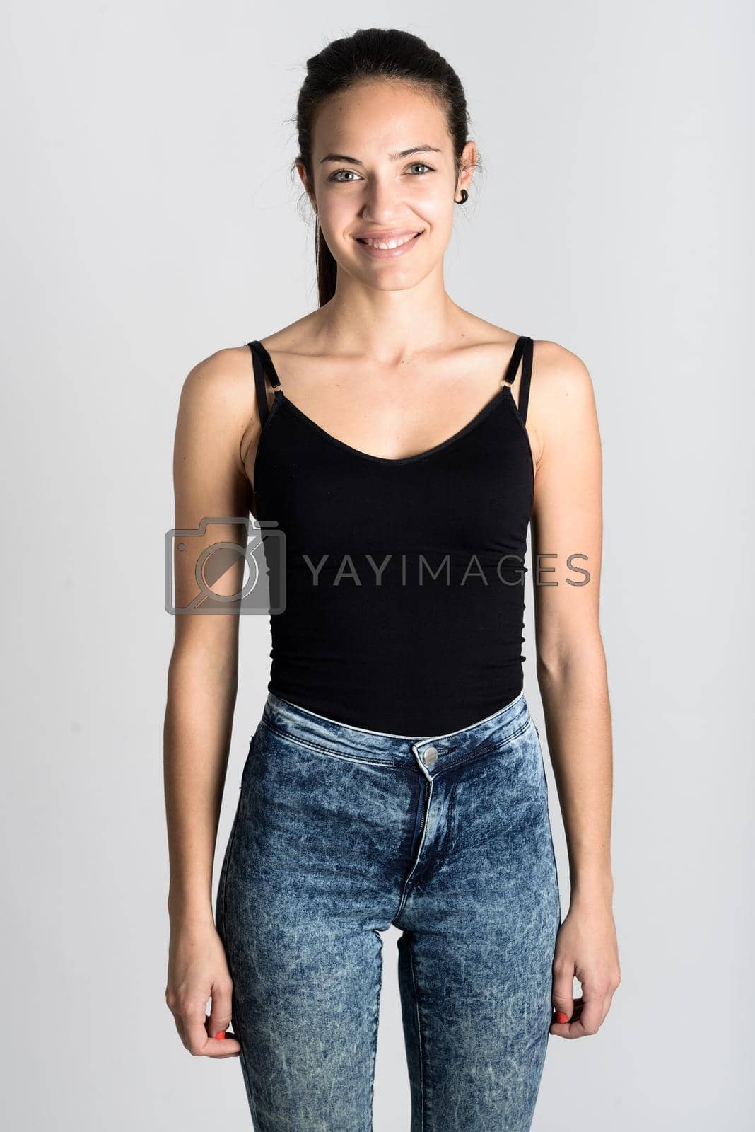 Royalty free image of Young woman wearing black tank top and blue jeans by javiindy