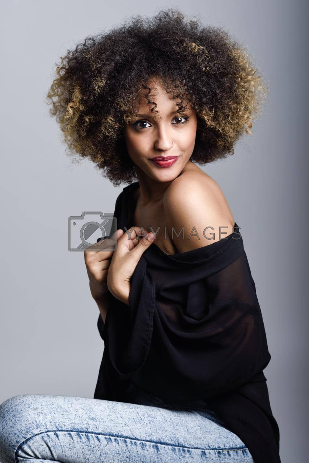Royalty free image of Young black woman with afro hairstyle by javiindy