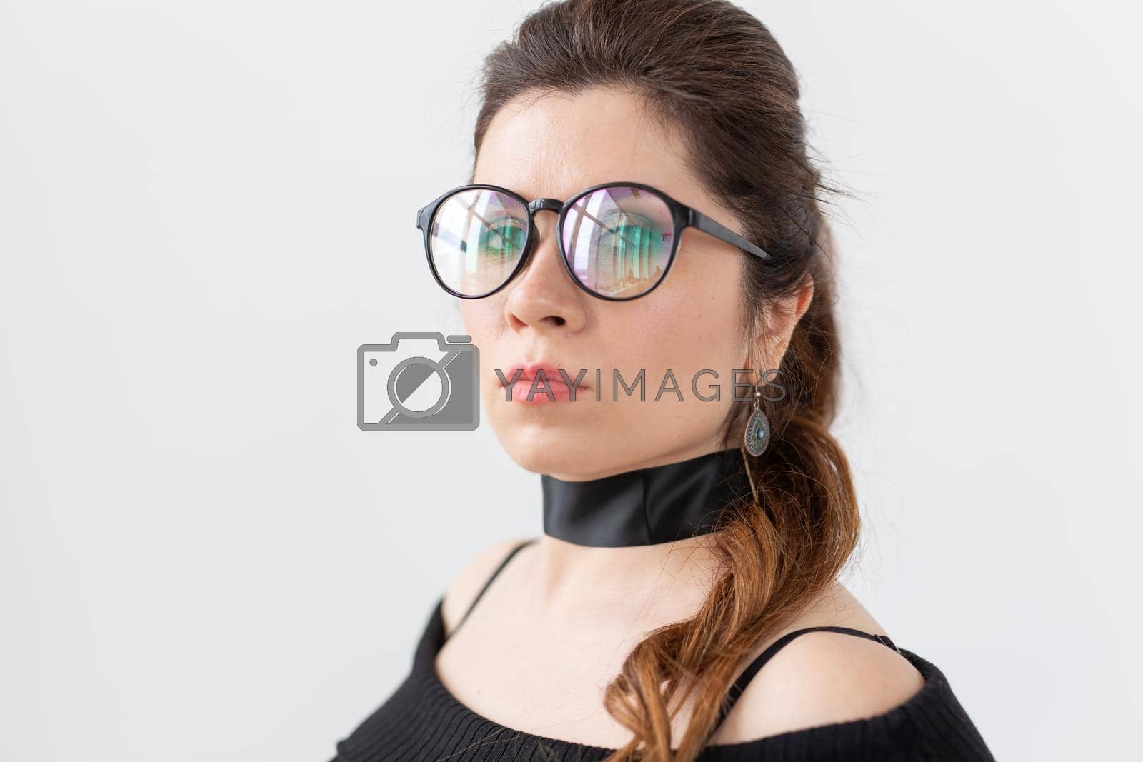Royalty free image of Portrait, fashion, style and people concept - woman in glasses and choker on white background by Satura86