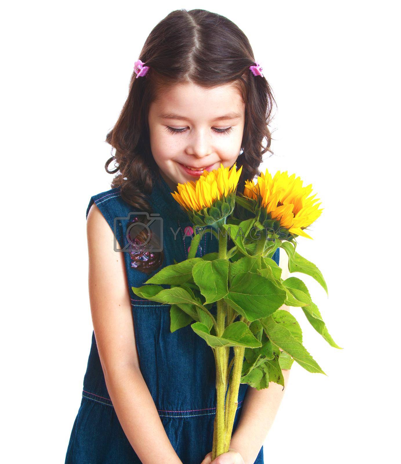 Royalty free image of Adorable little girl is smelling flowers. by kolesnikov_studio