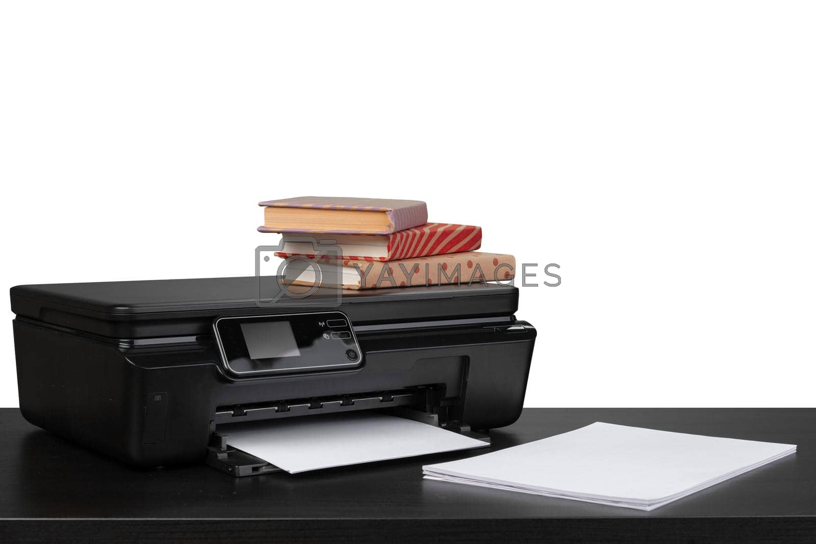 Royalty free image of Working table with printer and stacked books on white abckground by Fabrikasimf