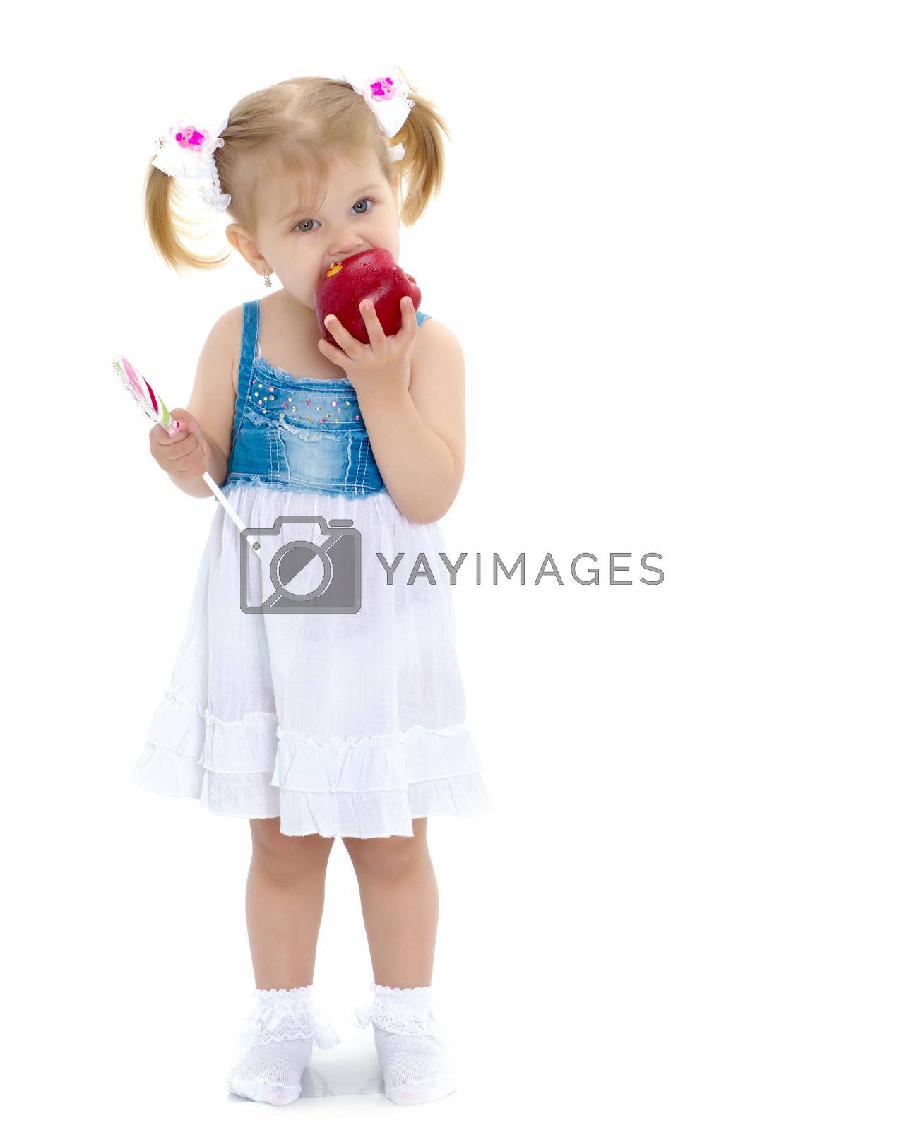 Royalty free image of Little girl with apple by kolesnikov_studio