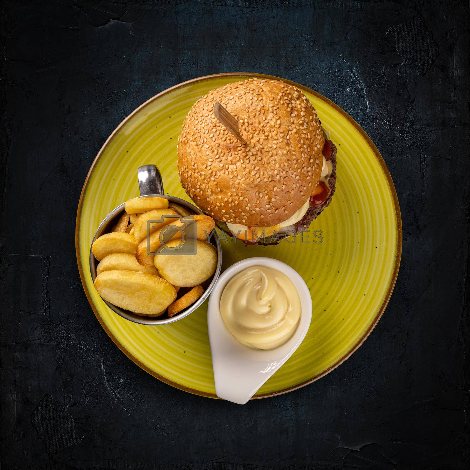 Royalty free image of Burger served with potatoes and mayonnaise by grafvision