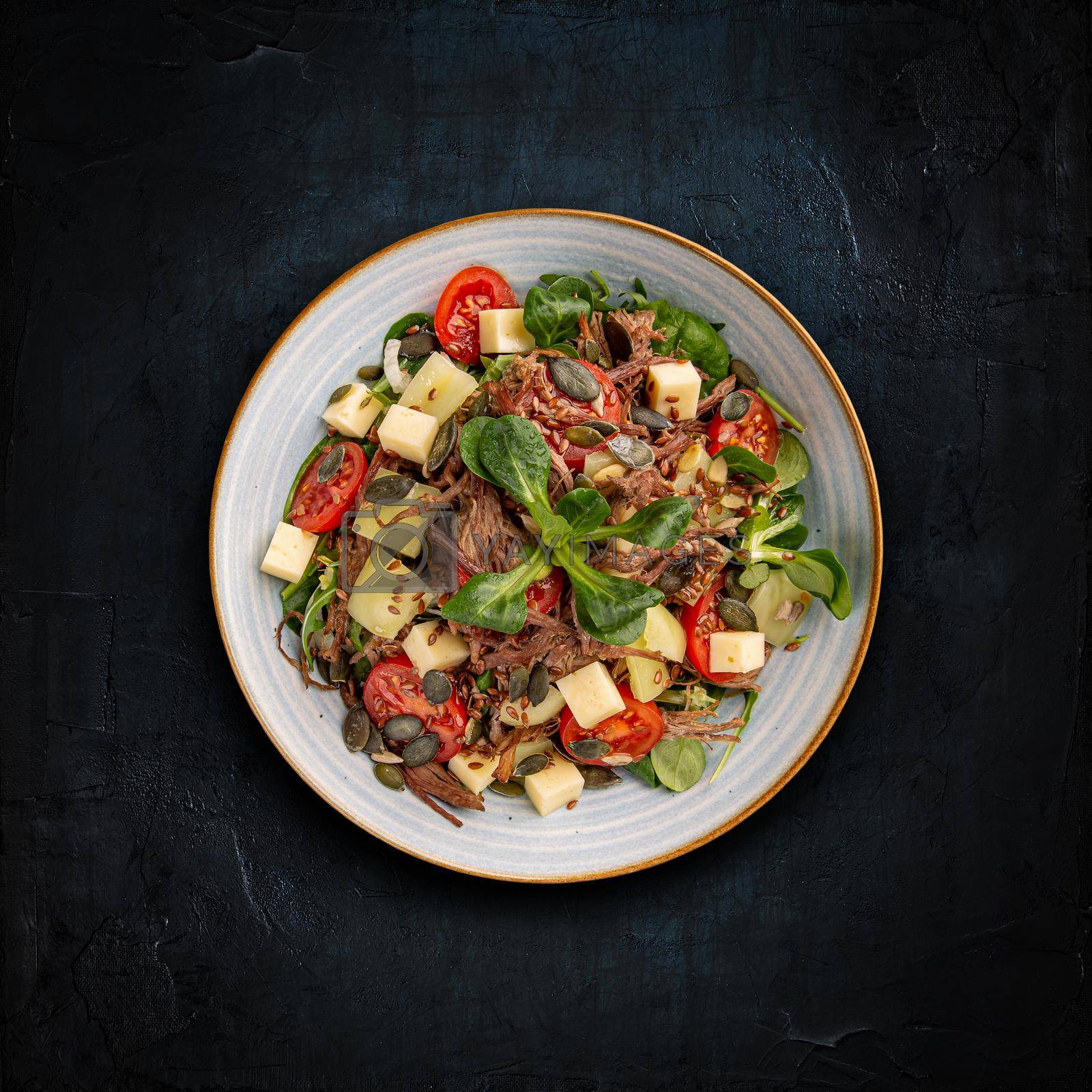 Pulled beef salad with cherry tomatoes and greens vegetables Healthy food concept.