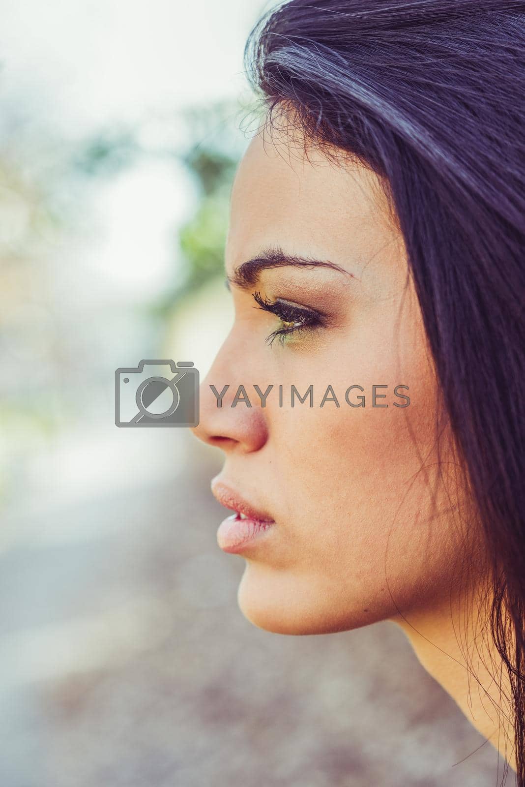 Royalty free image of Young woman with green eyes in urban background by javiindy