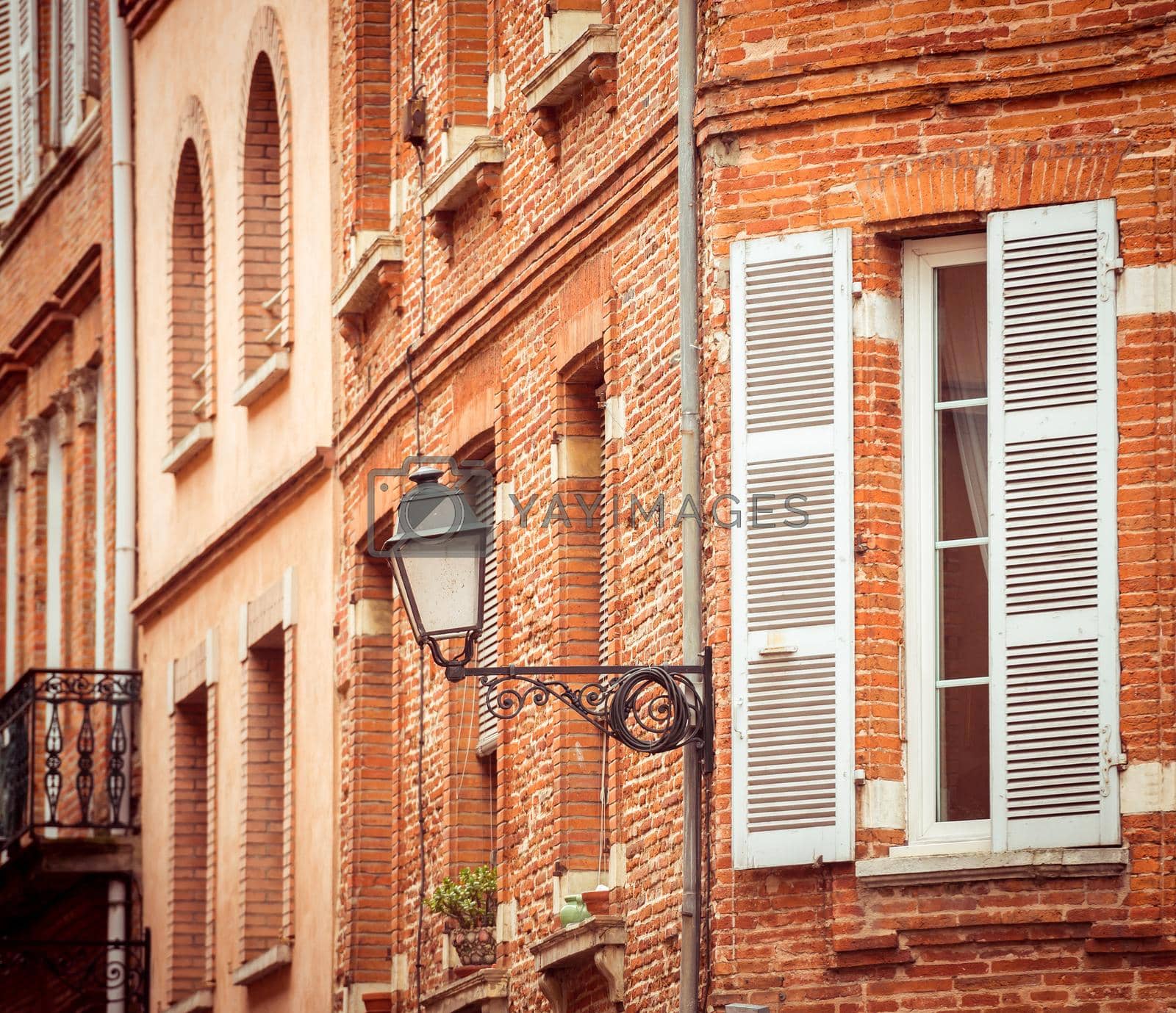 Royalty free image of street with old buildings in Toulouse by tan4ikk1