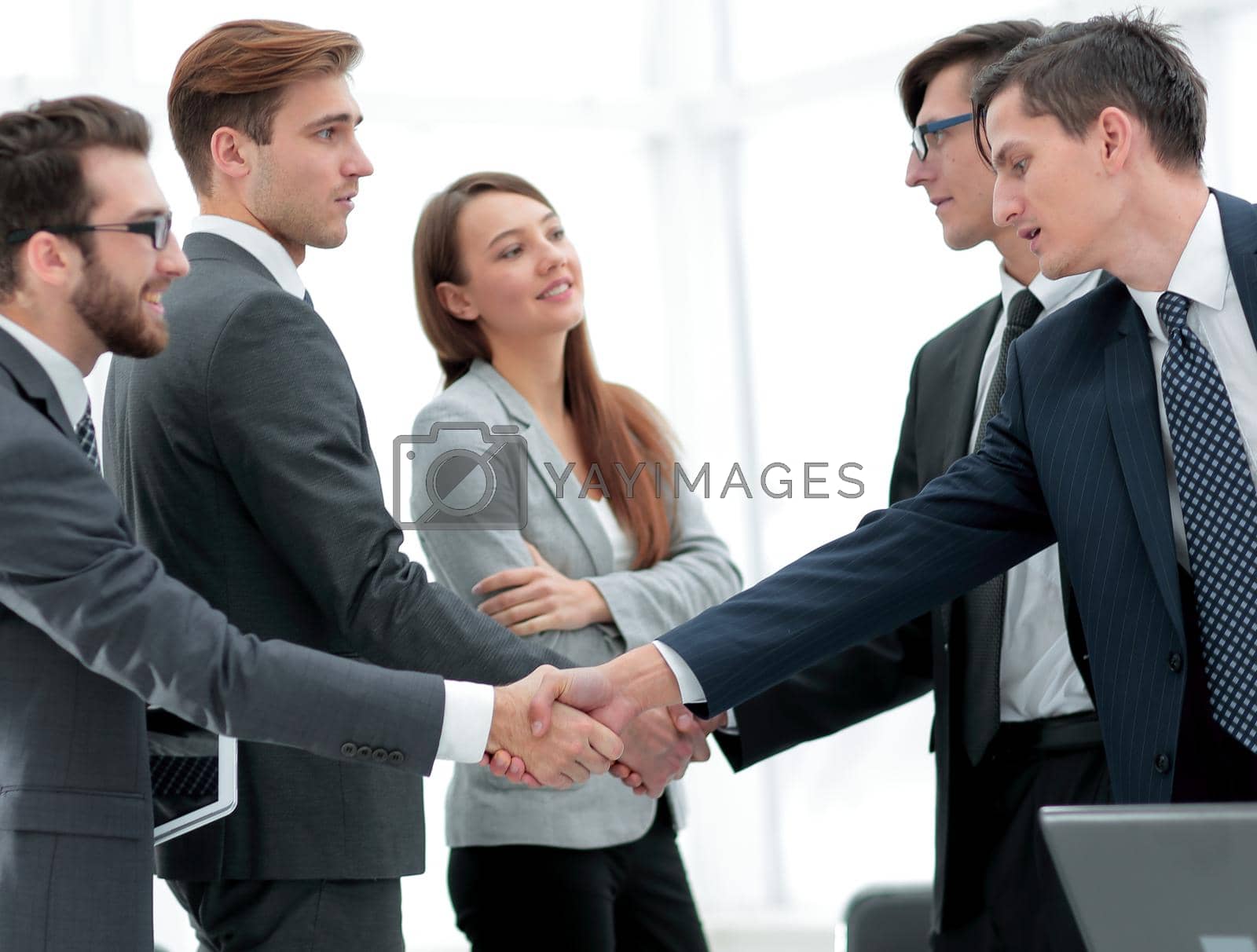 Royalty free image of leaders of business teams shake hands by asdf