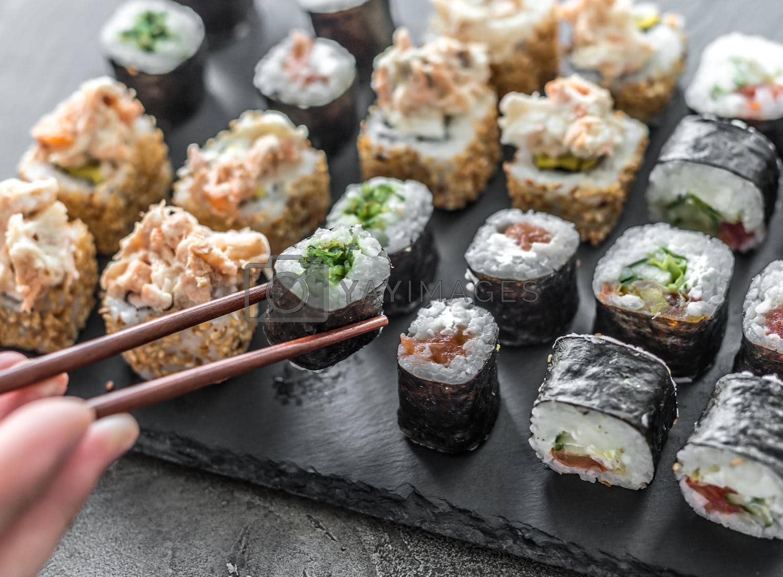 Royalty free image of Sushi set on a rectangular board by tan4ikk1
