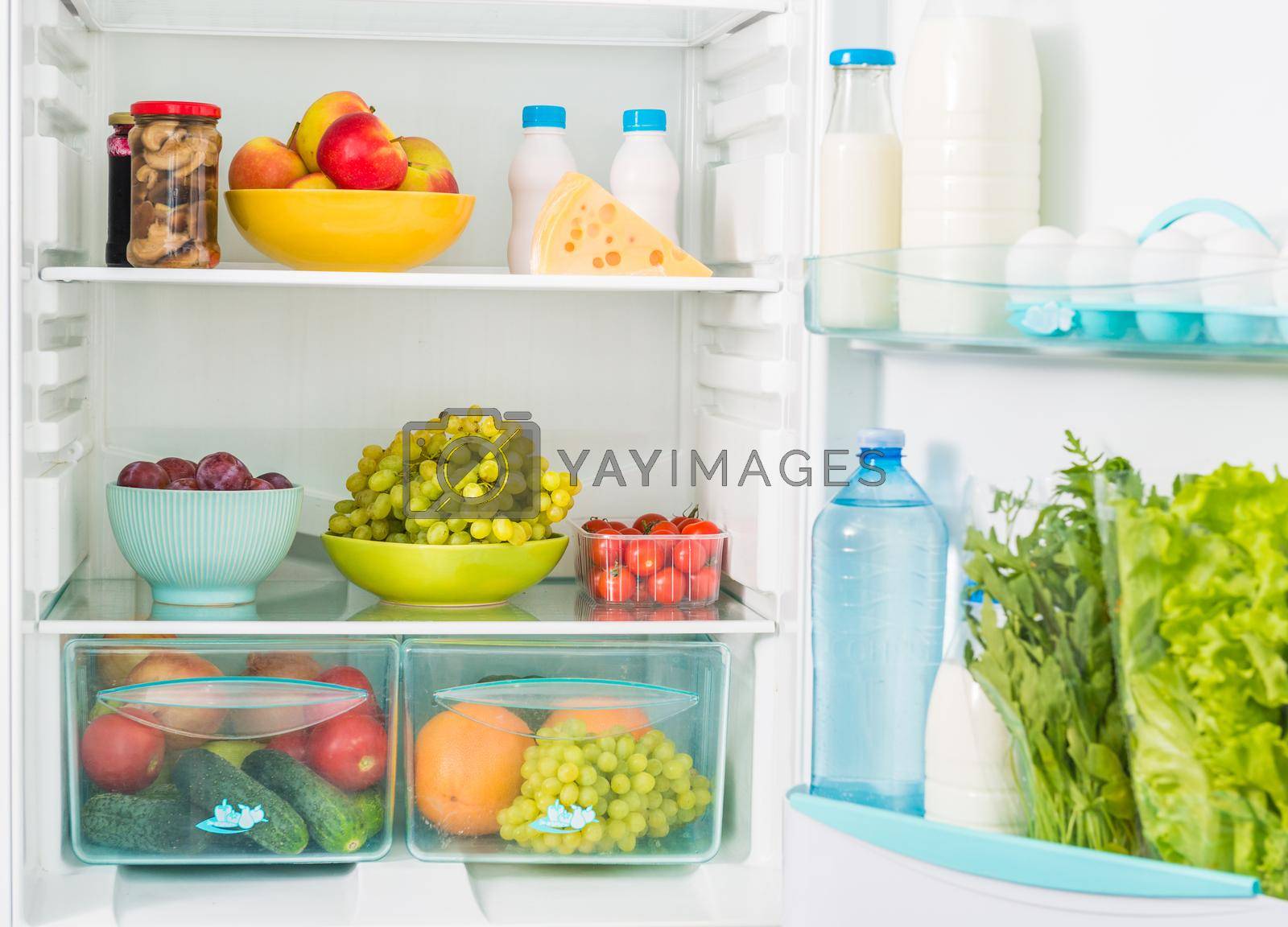 Royalty free image of fridge inseide with food by tan4ikk1