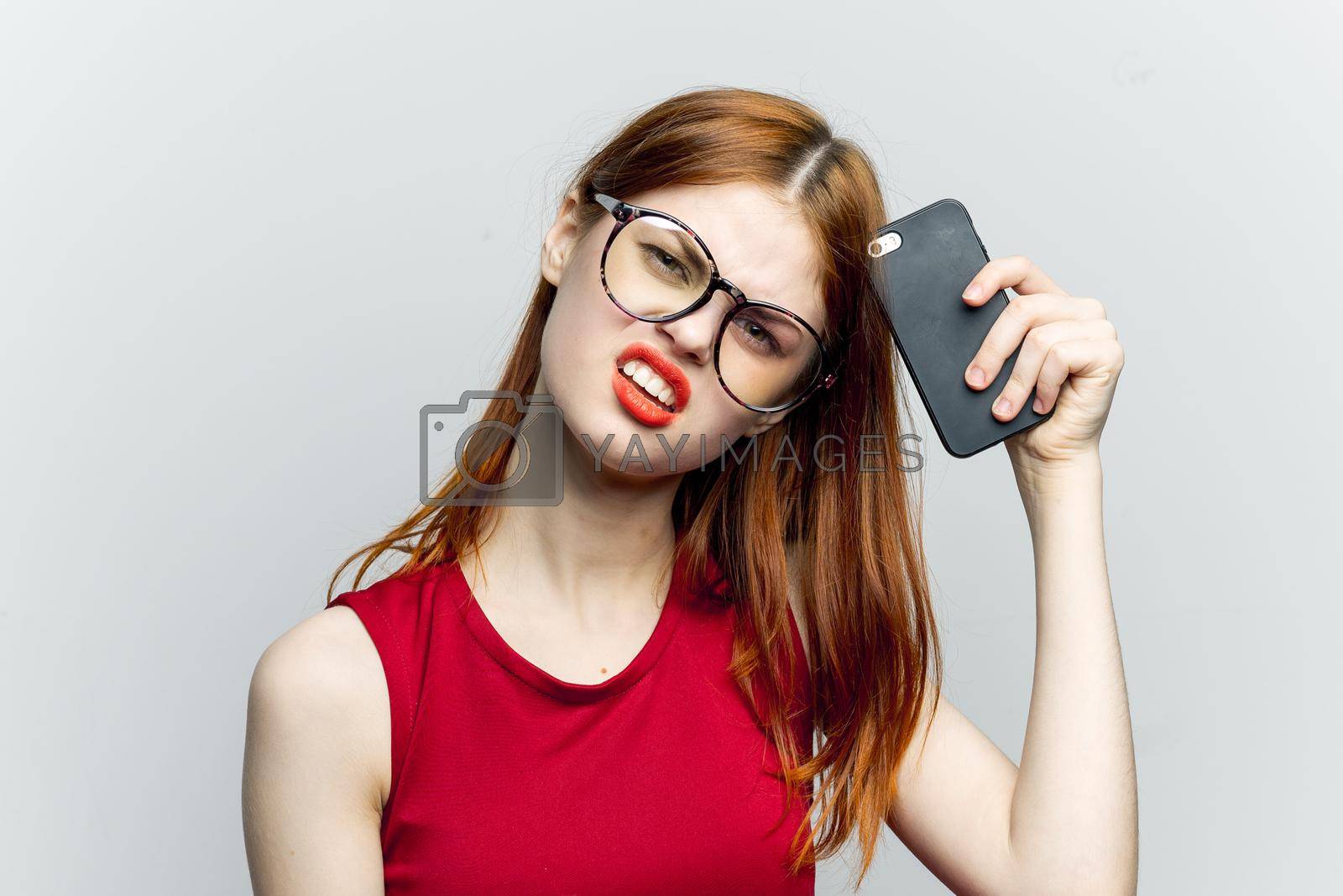 pretty woman in glasses with phone in hands communication technology. High quality photo