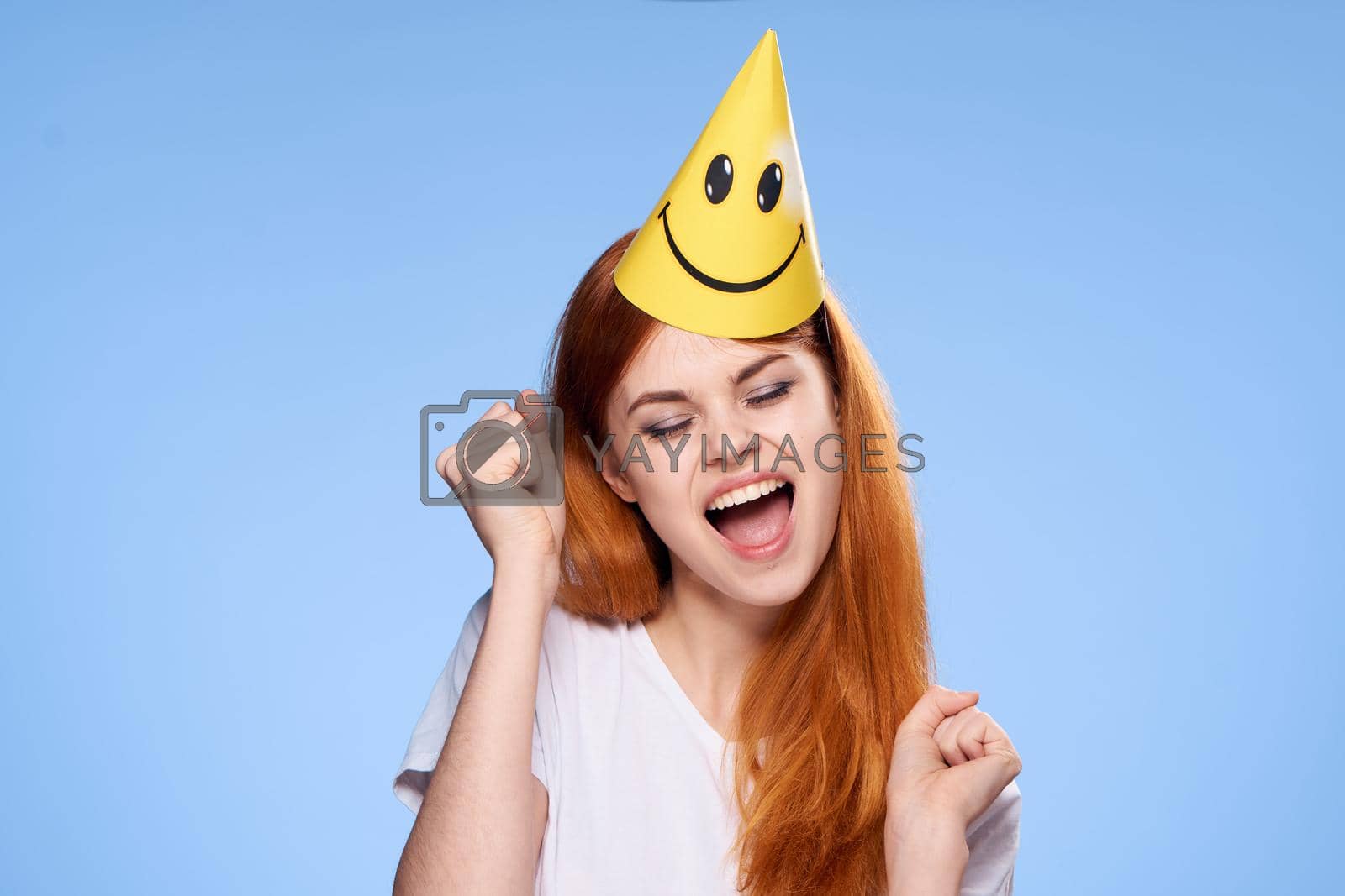 woman with red hair cap on her head birthday celebration. High quality photo