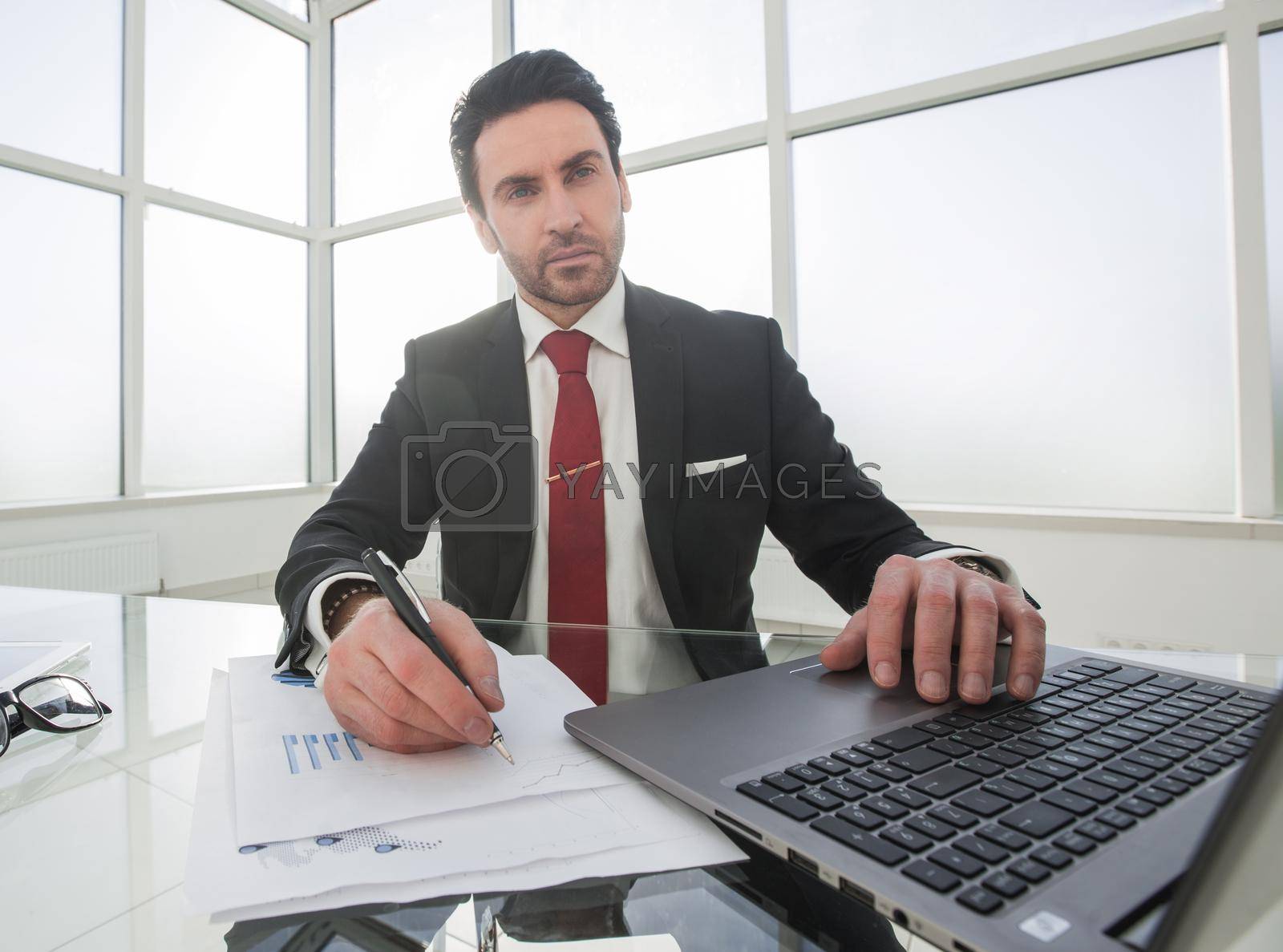 confident businessman working with financial documents. business concept