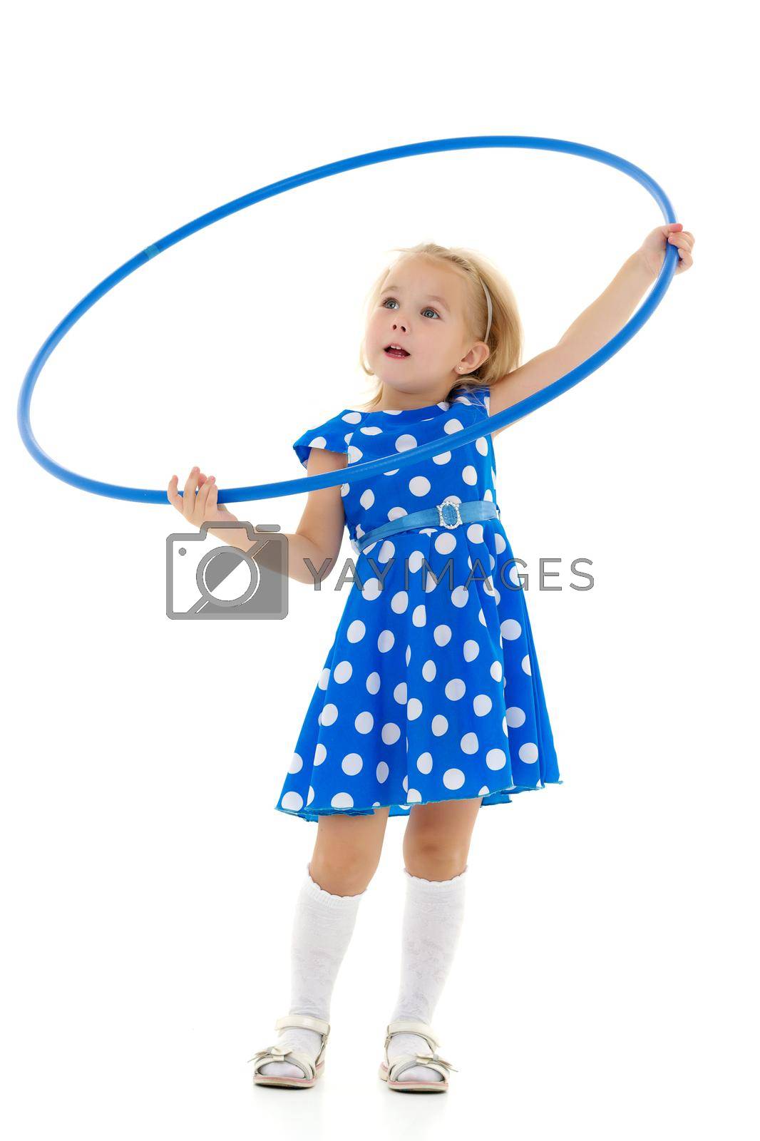 Royalty free image of The little girl turns the hoop. by kolesnikov_studio