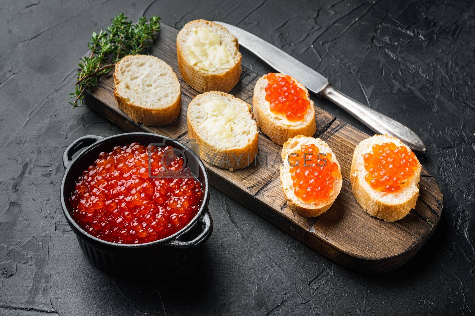 Royalty free image of Canape toast with red caviar, on black background by Ilianesolenyi