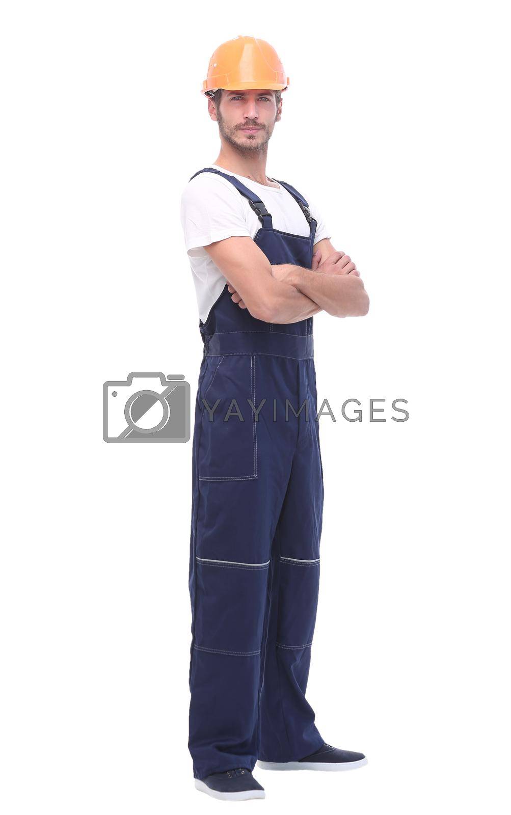 Royalty free image of in full growth. confident man wearing overalls and a crash helmet. by asdf
