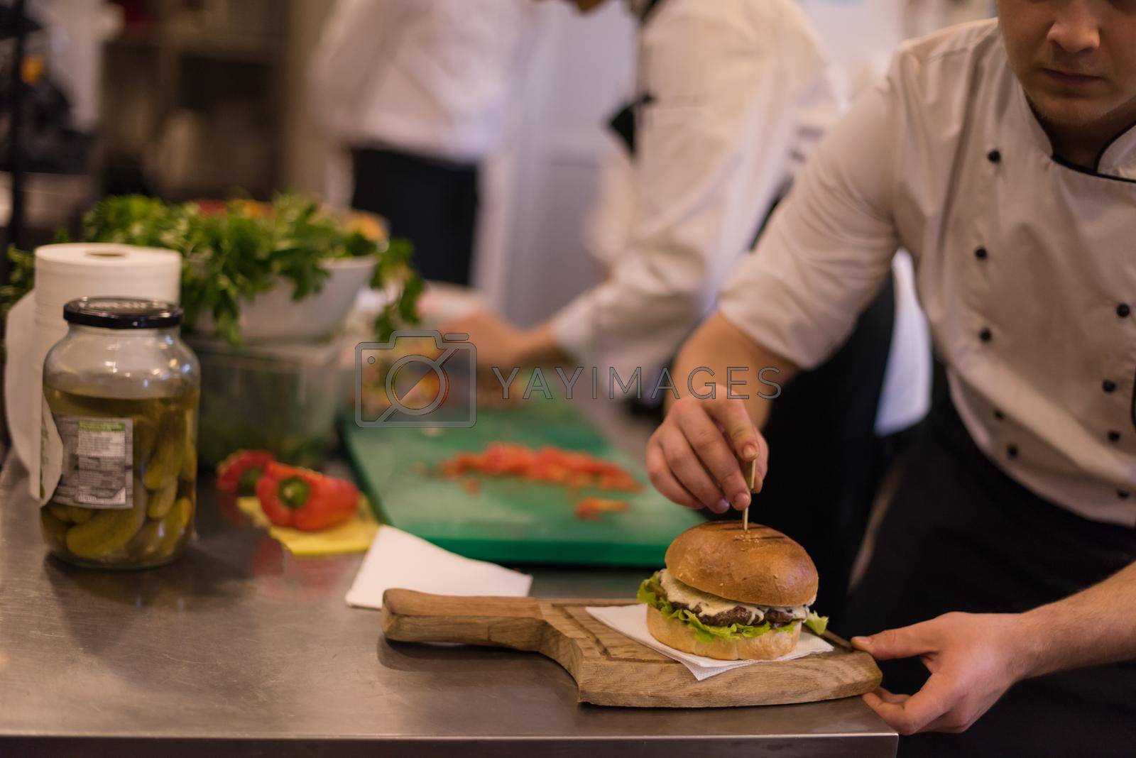 Royalty free image of chef finishing burger by dotshock