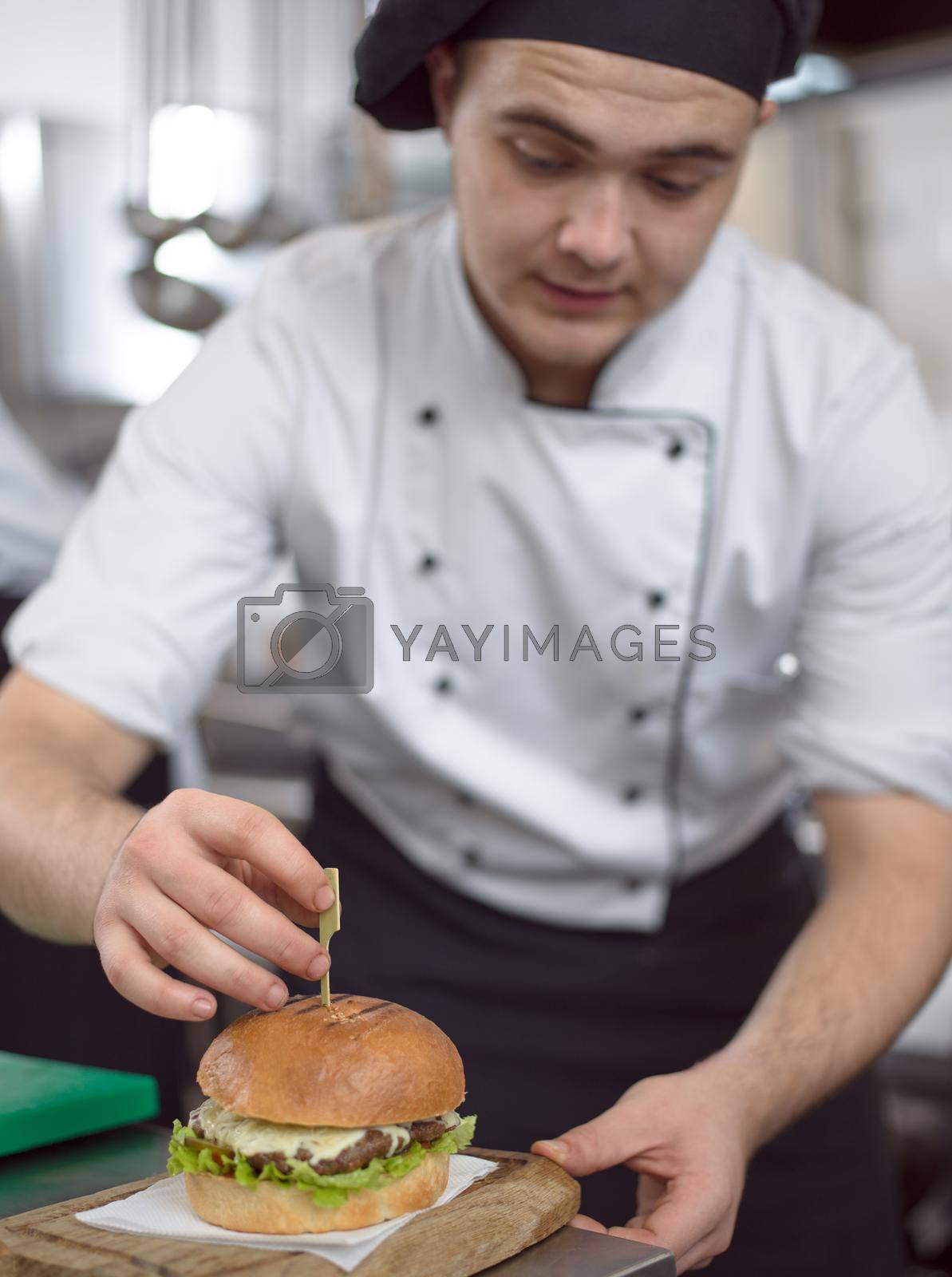 Royalty free image of chef finishing burger by dotshock