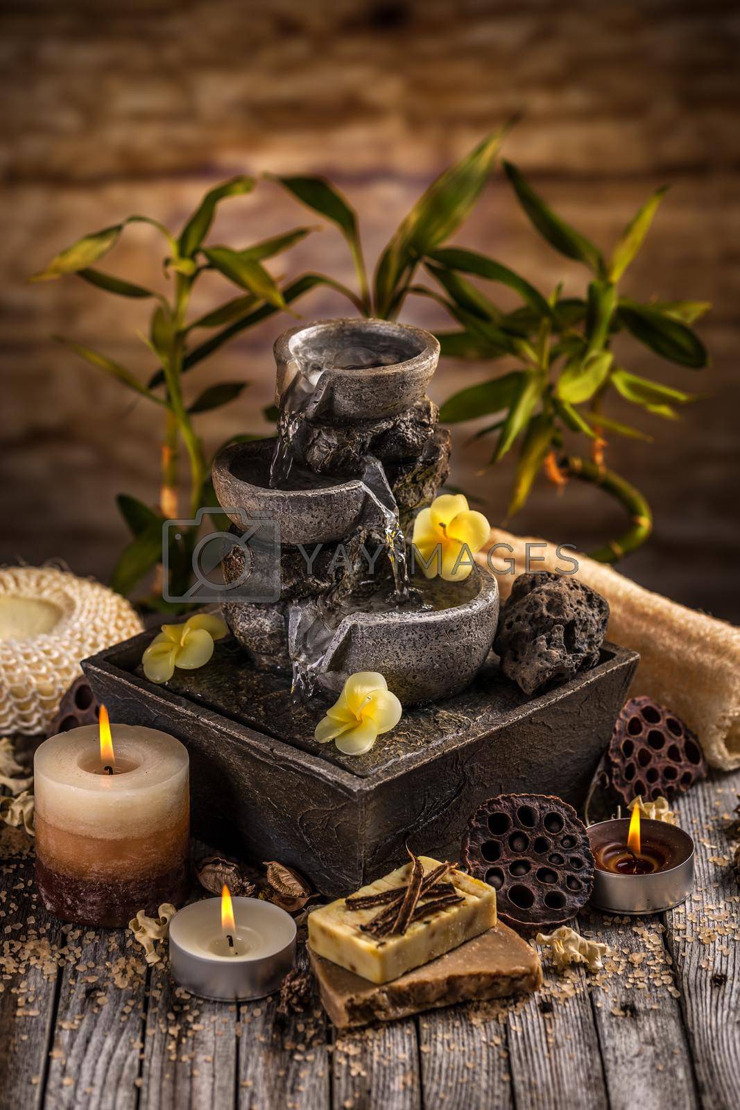Spa still life with aromatic candles and water fountain