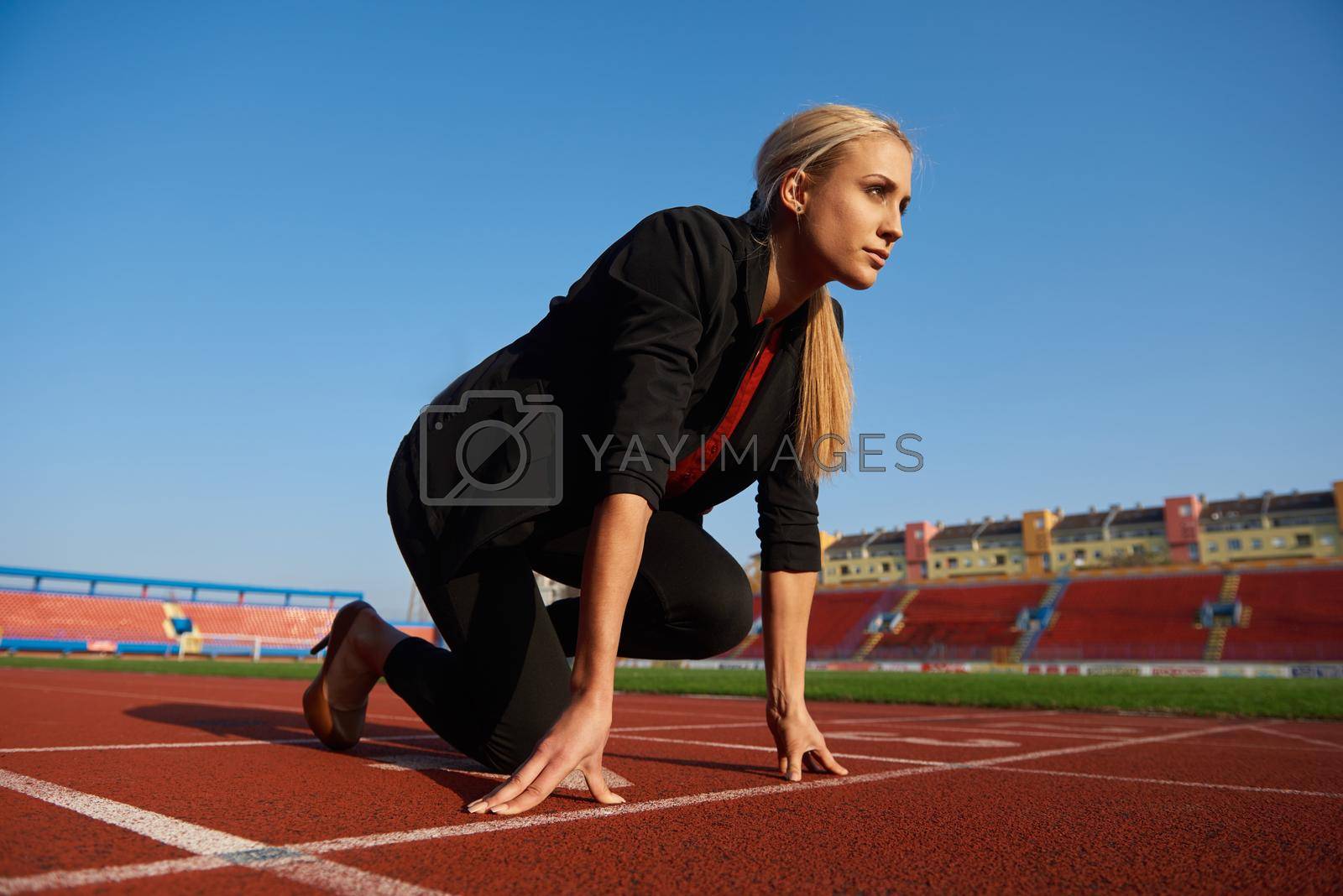 Royalty free image of business woman ready to sprint by dotshock