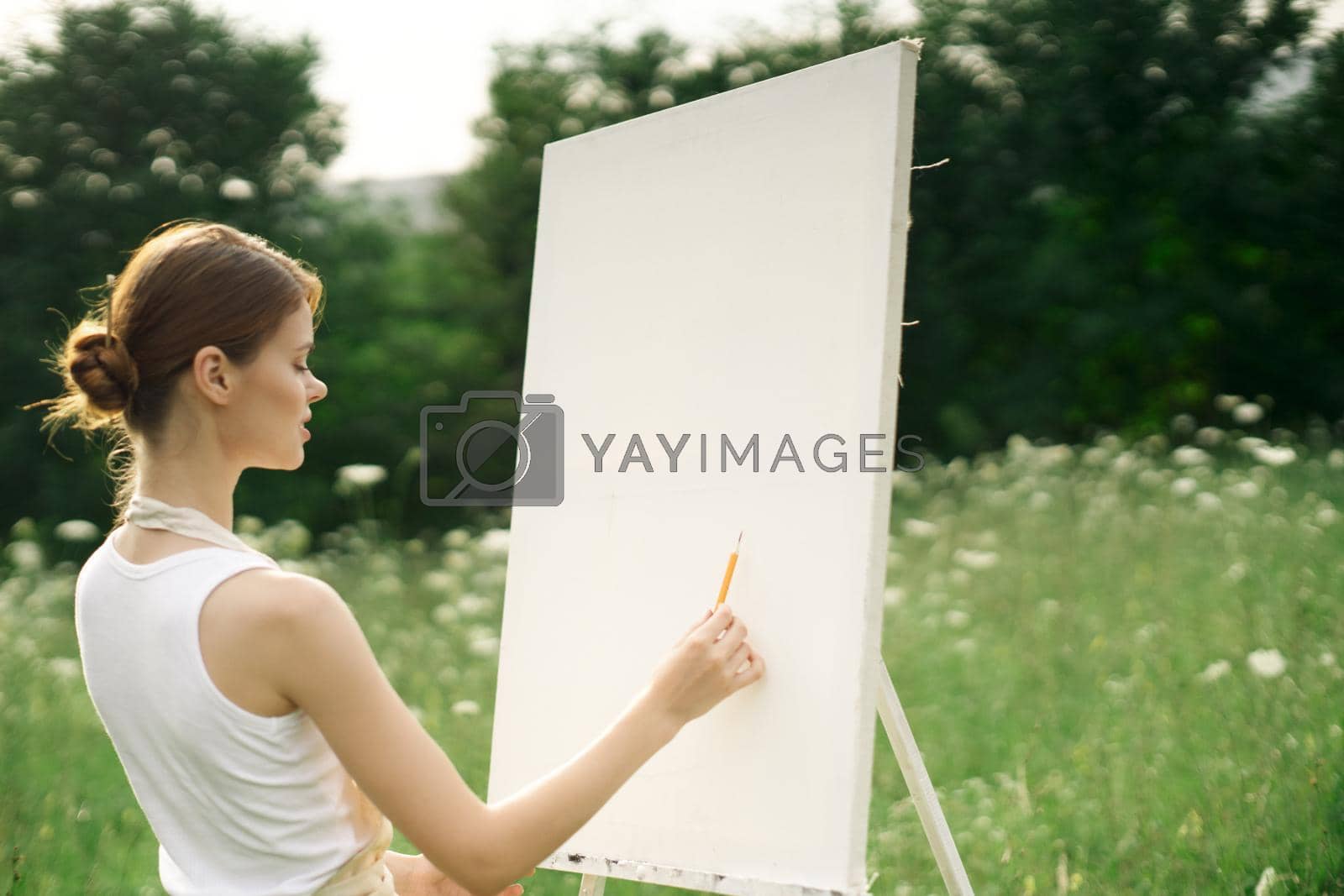 Royalty free image of woman artist nature drawing landscape art hobby by Vichizh