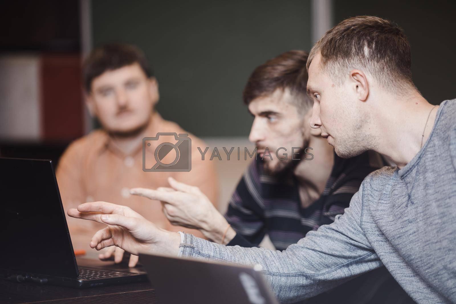 Royalty free image of People in classroom using laptops by Demkat