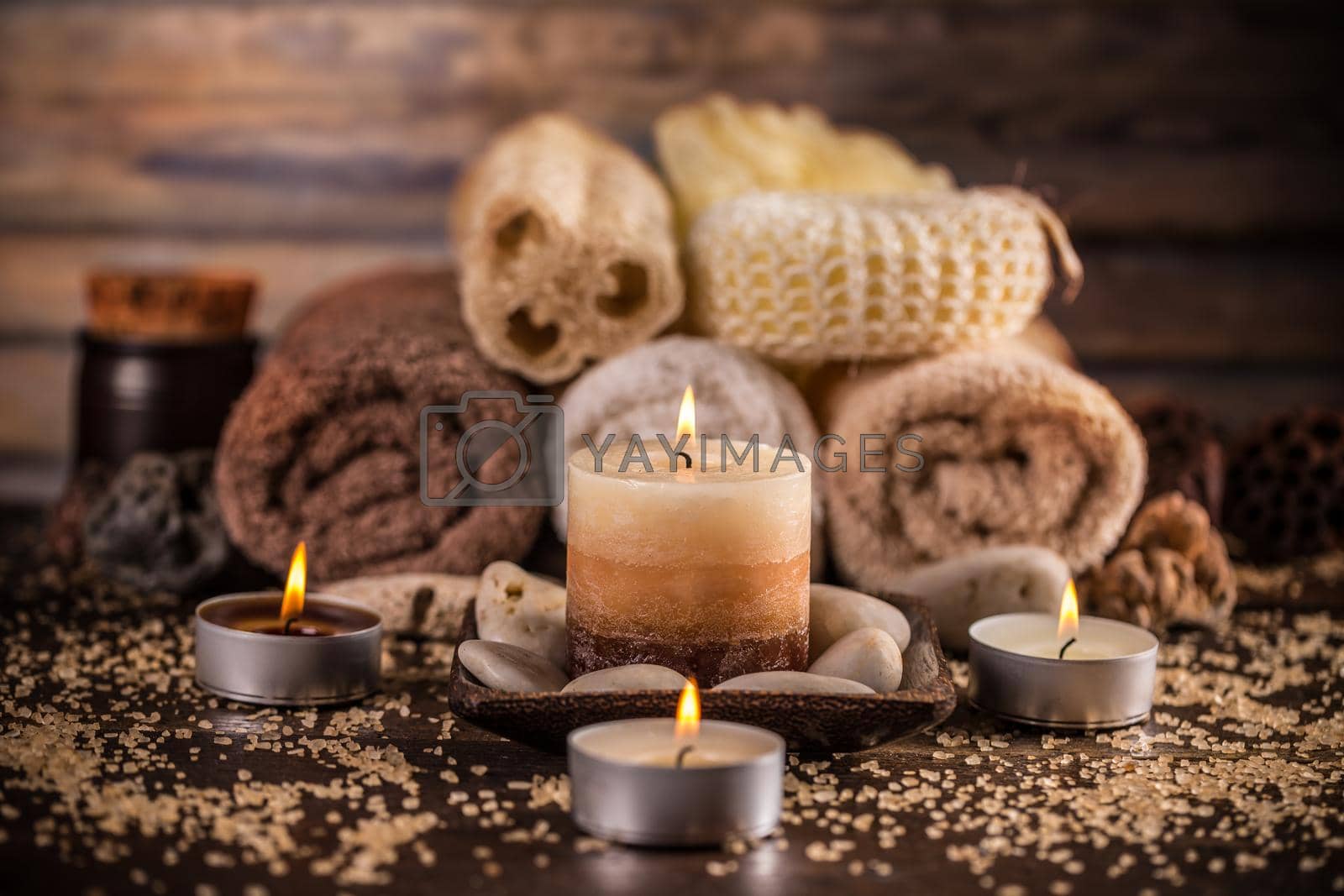 Spa and wellness setting with towels and candles