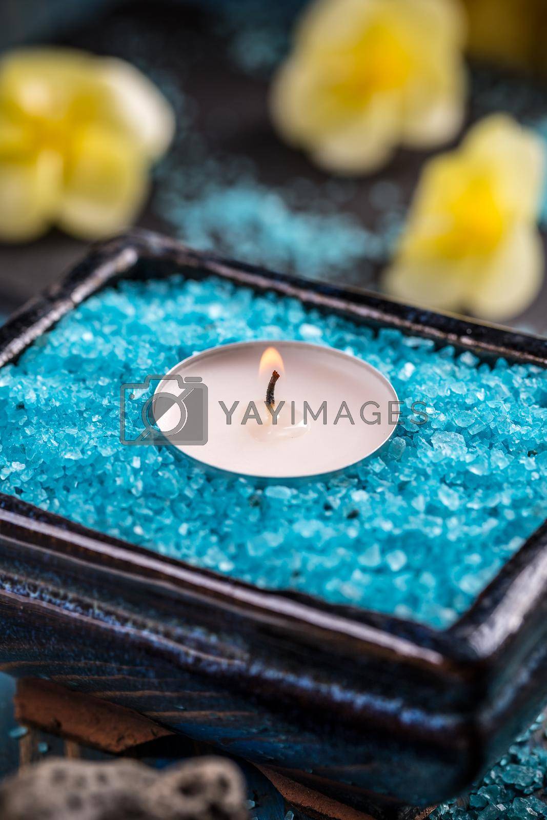 Spa background, candle in a bowl with salt baths 
