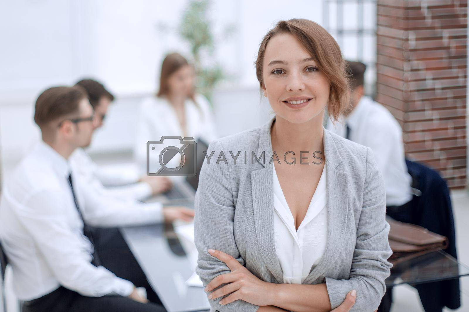 Royalty free image of portrait of young business woman on blurred office background by asdf