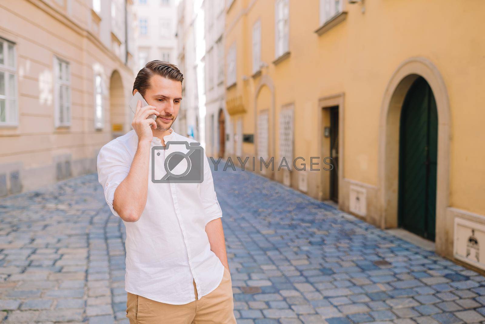 Royalty free image of Young man background the old european city take selfie by travnikovstudio