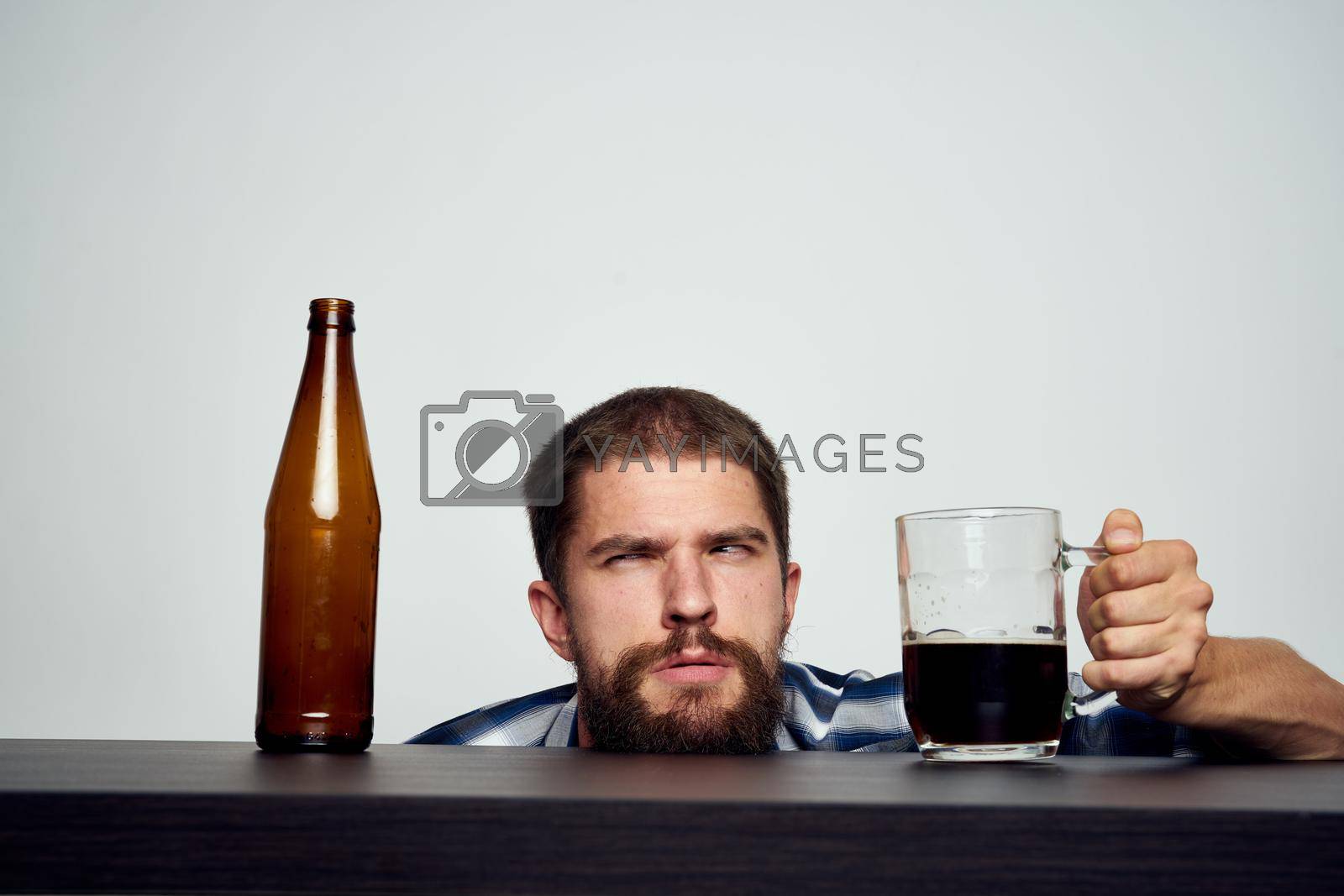 Royalty free image of bearded man drinking beer alcohol emotion light background by Vichizh